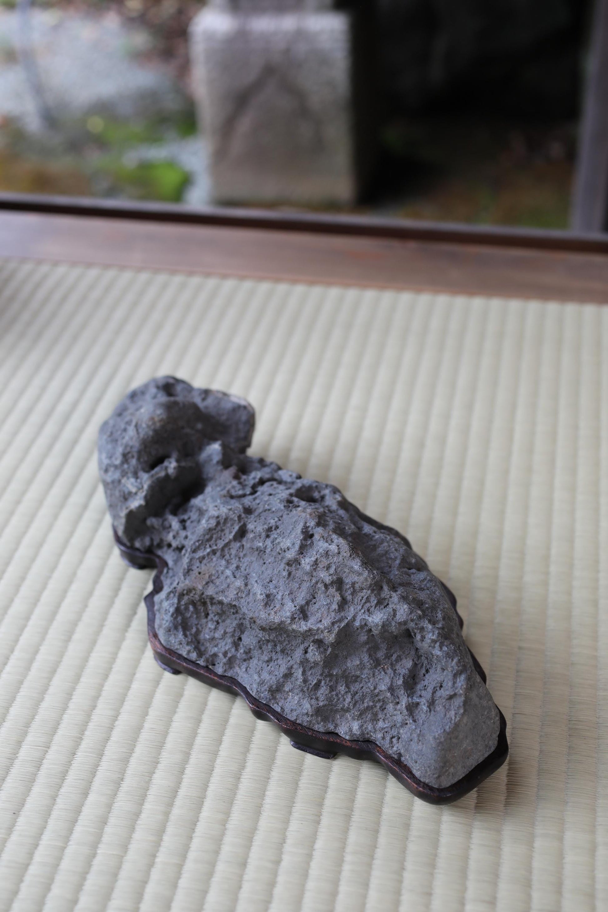 a large, gray rock sitting on a white mat.
