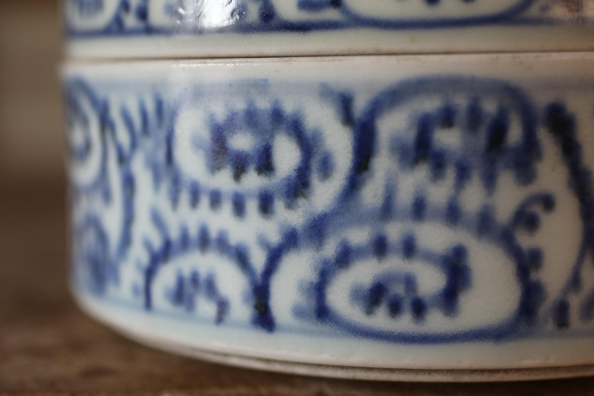 A close-up view of a decorative ceramic bowl or vase with a blue and white floral pattern.