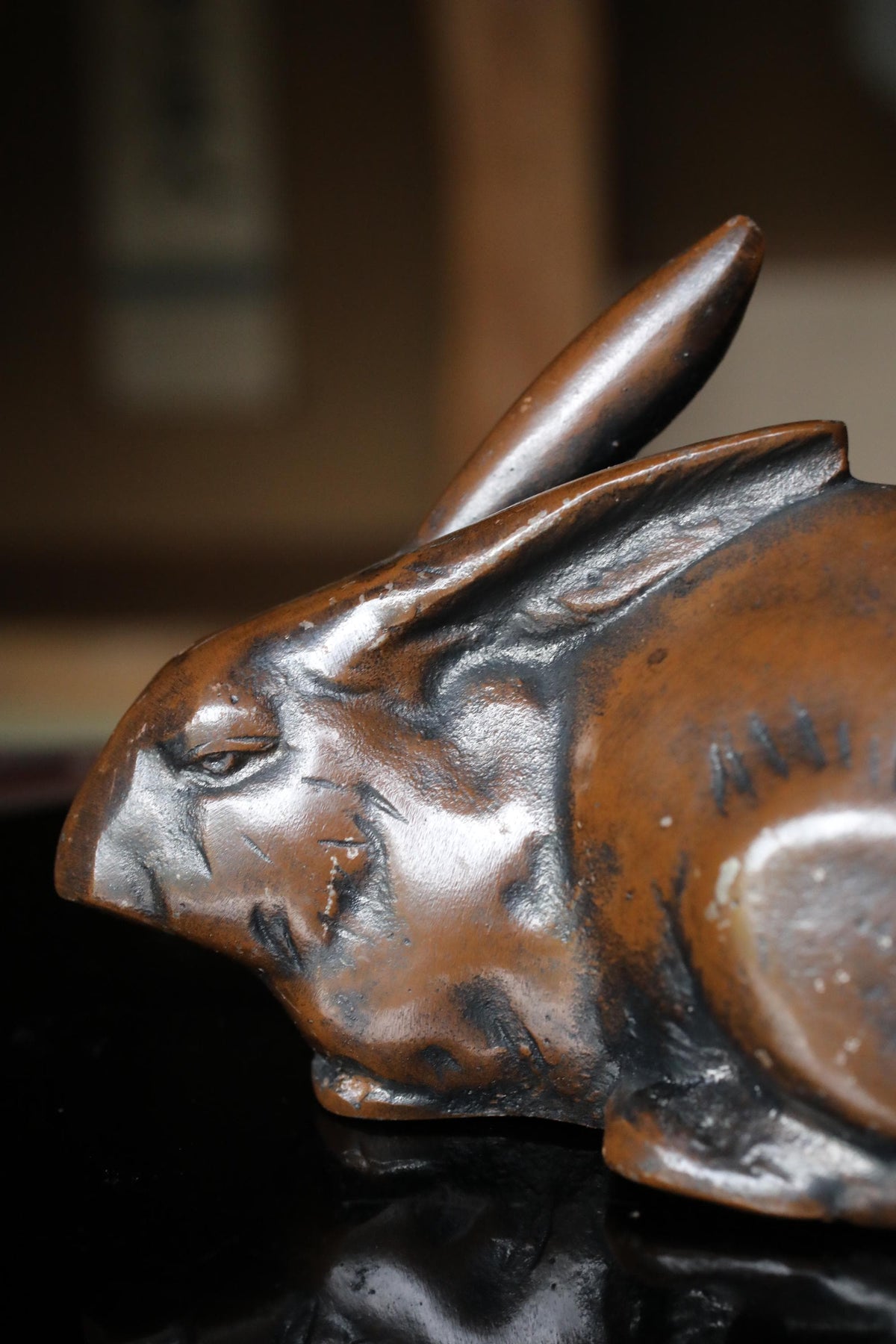 A bronze sculpture of a rabbit is shown in the image.