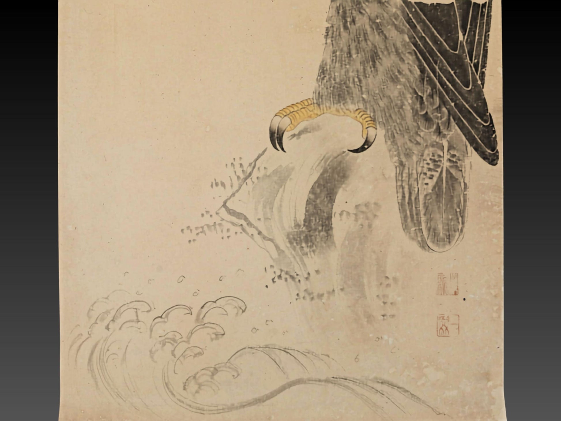 The image is a Japanese woodblock print depicting a bird of prey, likely an eagle, with its talons gripping a branch. The bird's head is turned to the left, and the background features a wave-like pattern.