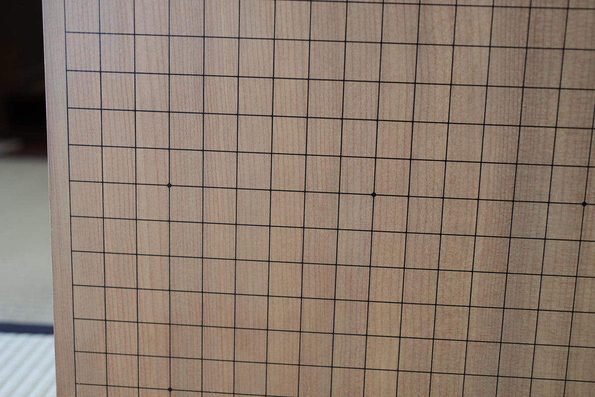 a close-up view of a wooden surface with a grid pattern, likely a piece of furniture or a decorative item.