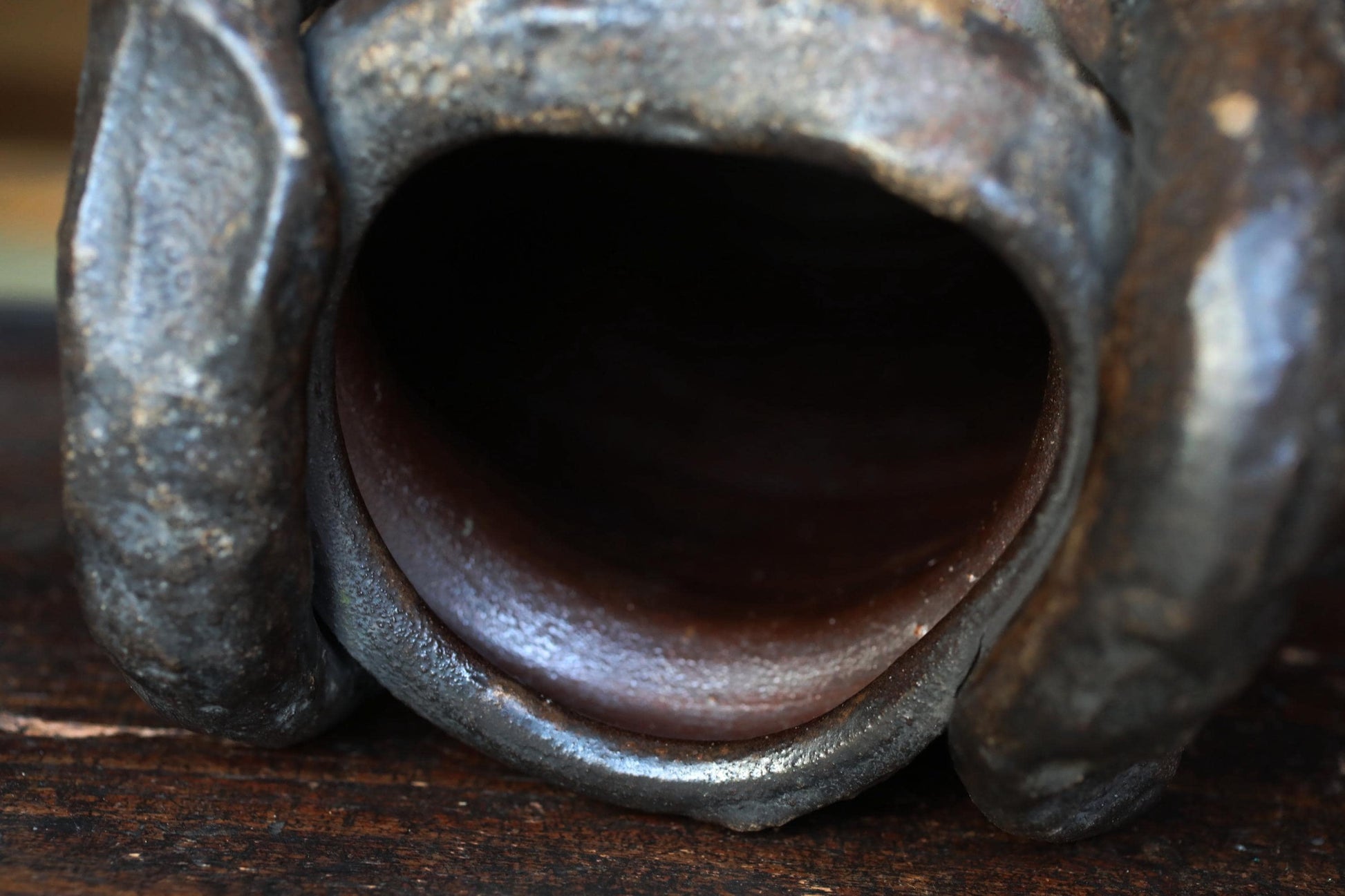 a close-up view of a metal object with a hole in the center, possibly a tool or a piece of machinery.