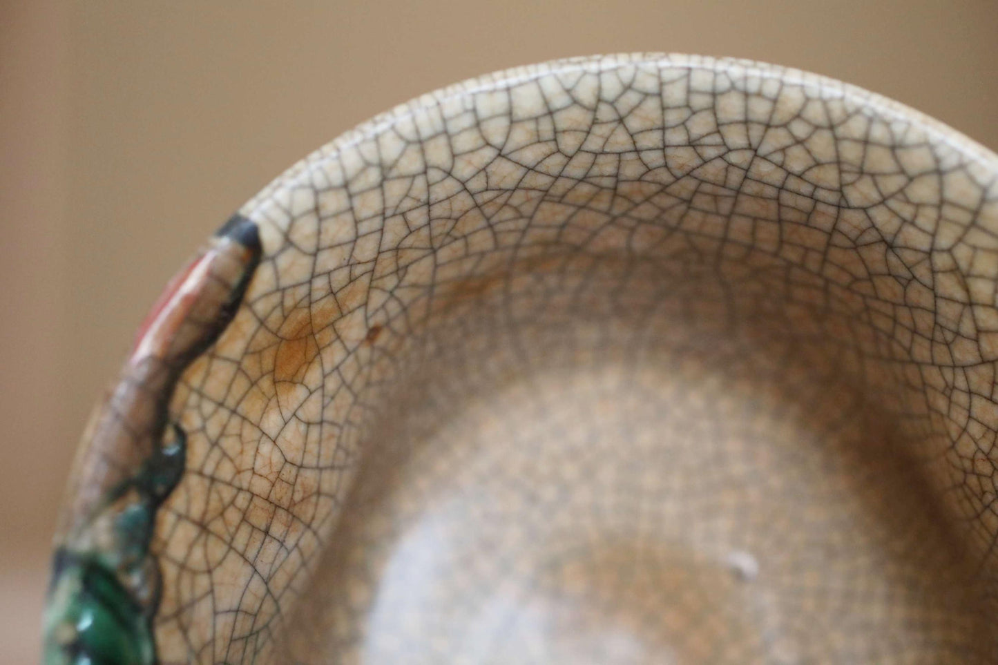 A close-up view of a ceramic bowl or dish with a textured, cracked surface.