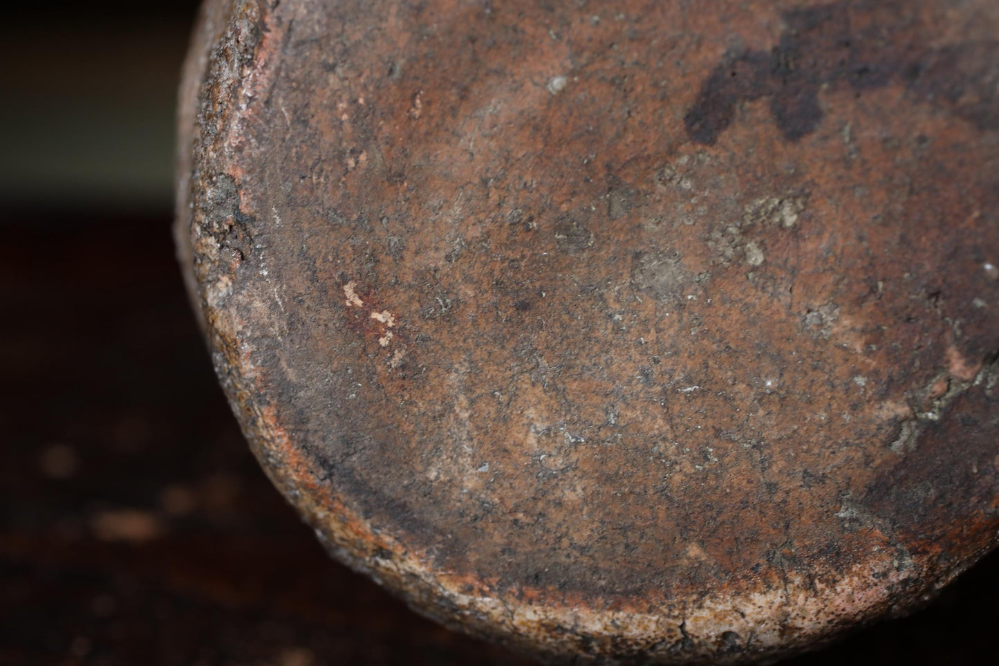 A close-up view of a rusted metal surface, with visible signs of wear and tear, including patches of rust and a rough, uneven texture.