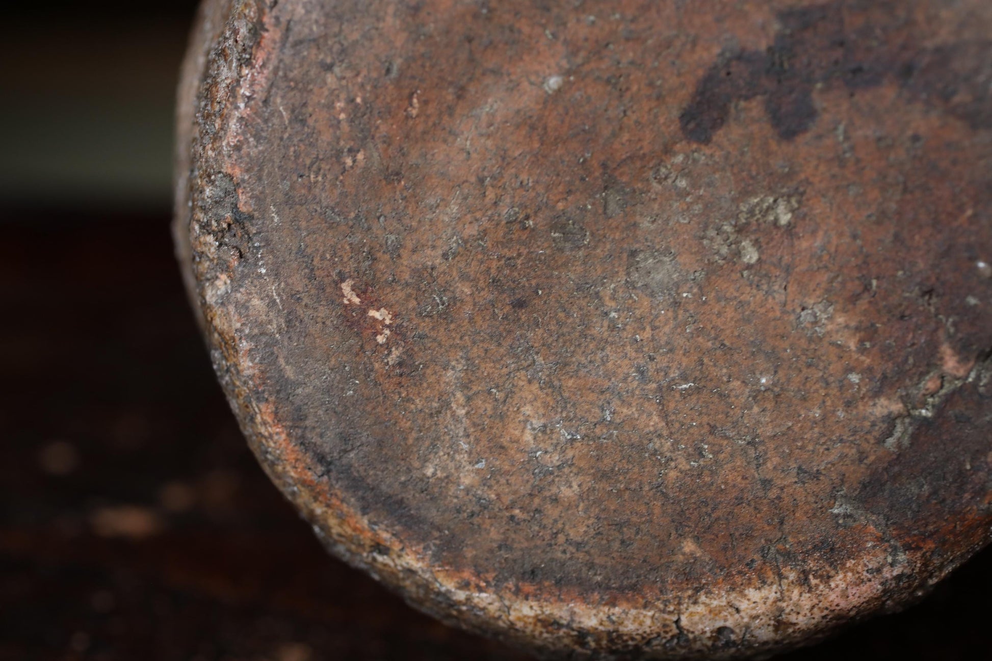 A close-up view of a rusted metal surface, with visible signs of wear and tear, including patches of rust and a rough, uneven texture.