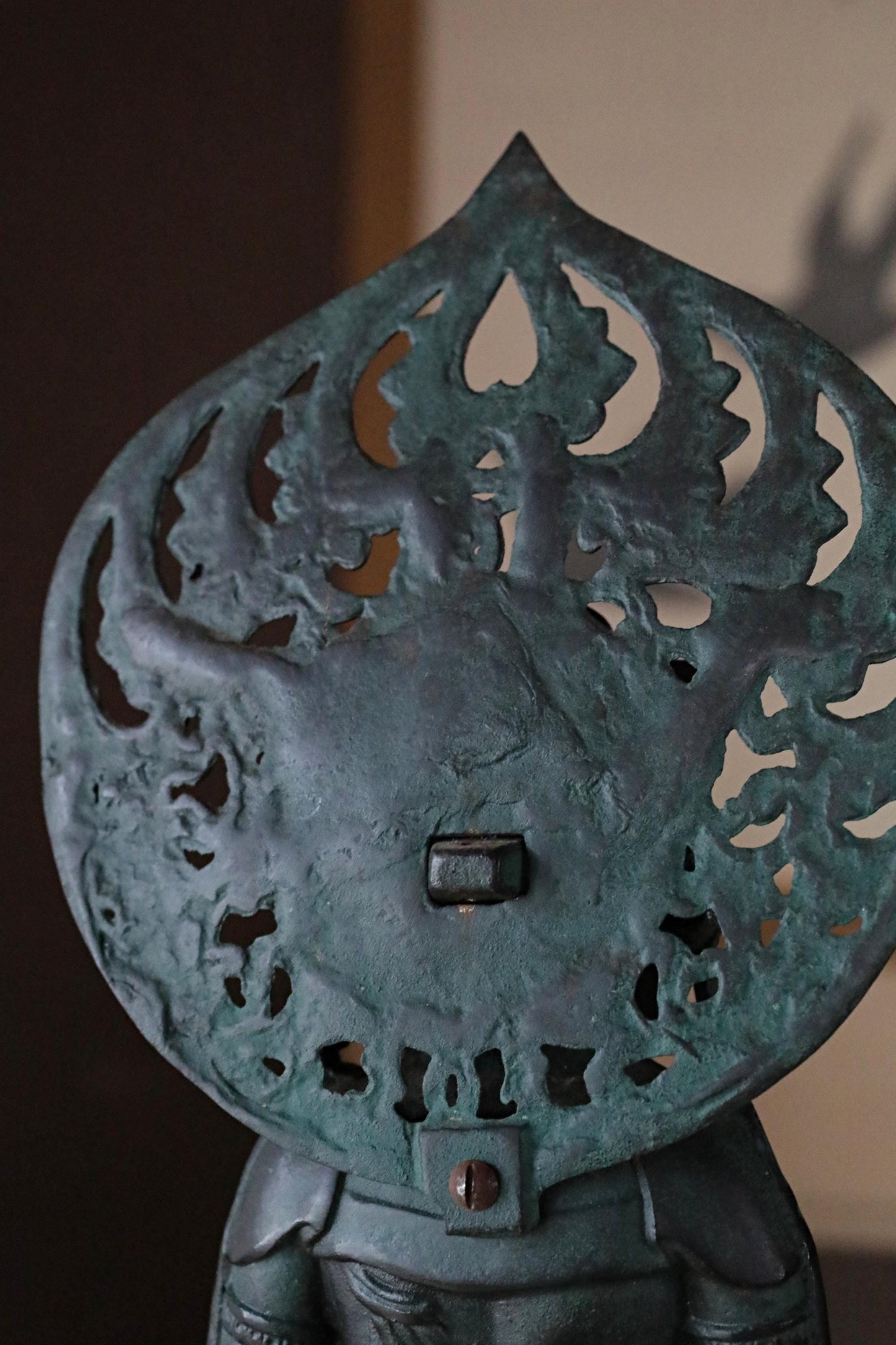 a close-up view of a decorative metal object, possibly a piece of art or a sculpture, with intricate patterns and designs.