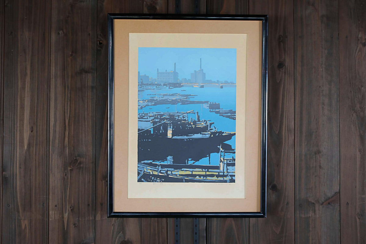 The image is a framed painting depicting a serene harbor scene with boats and buildings in the background.