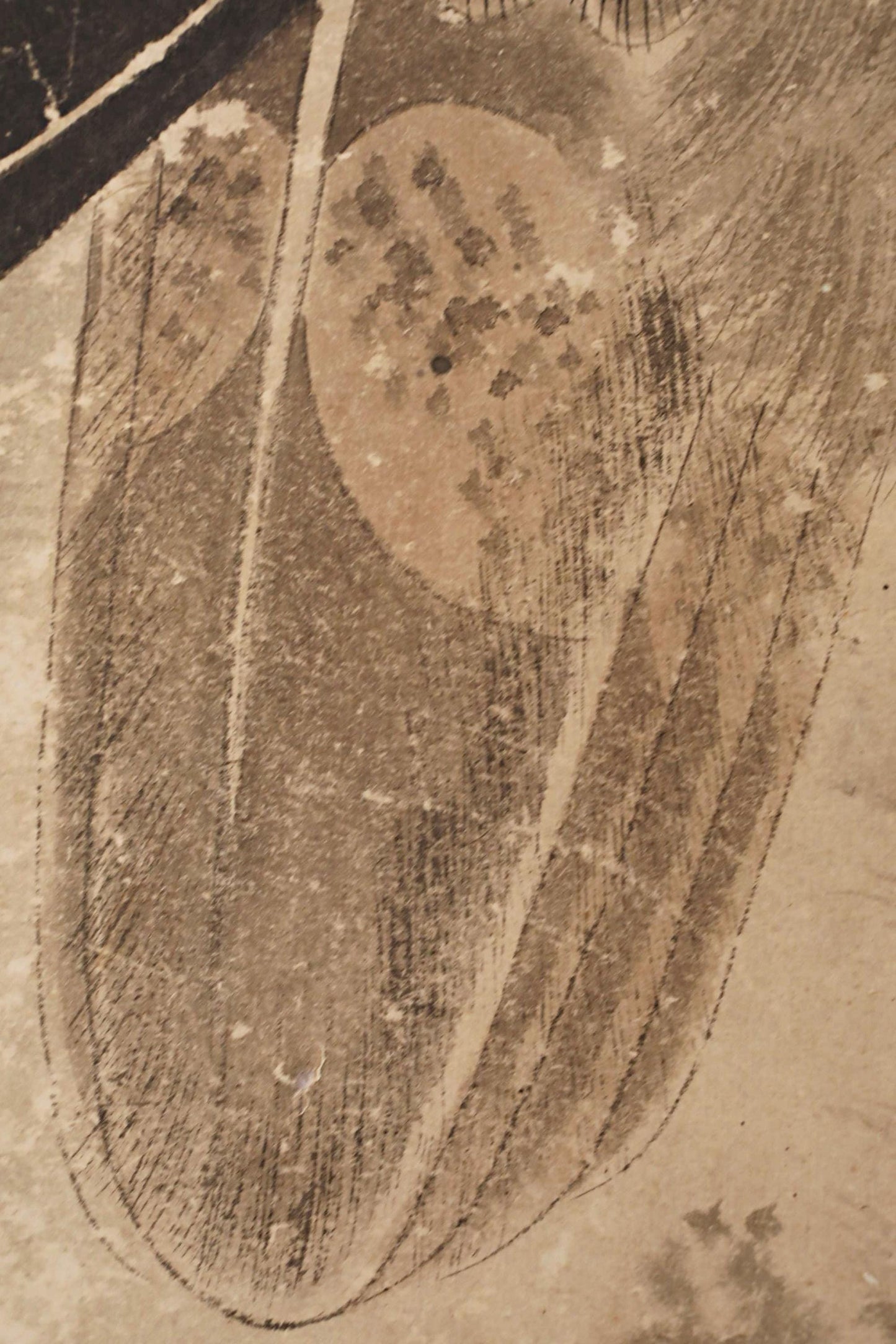 The image is a close-up of a leaf with intricate patterns and textures, including a large circular shape and smaller leaf-like shapes.