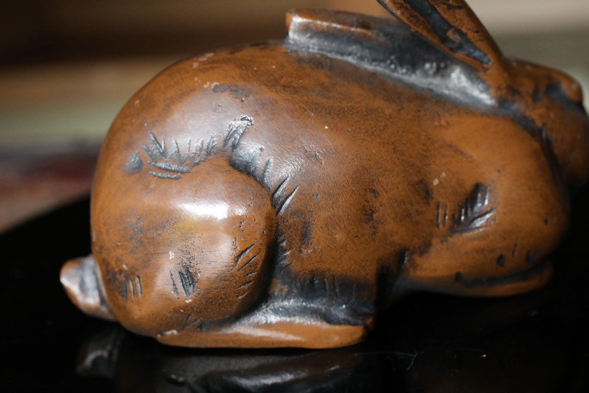 A close-up image of a brown, textured ceramic rabbit figurine.