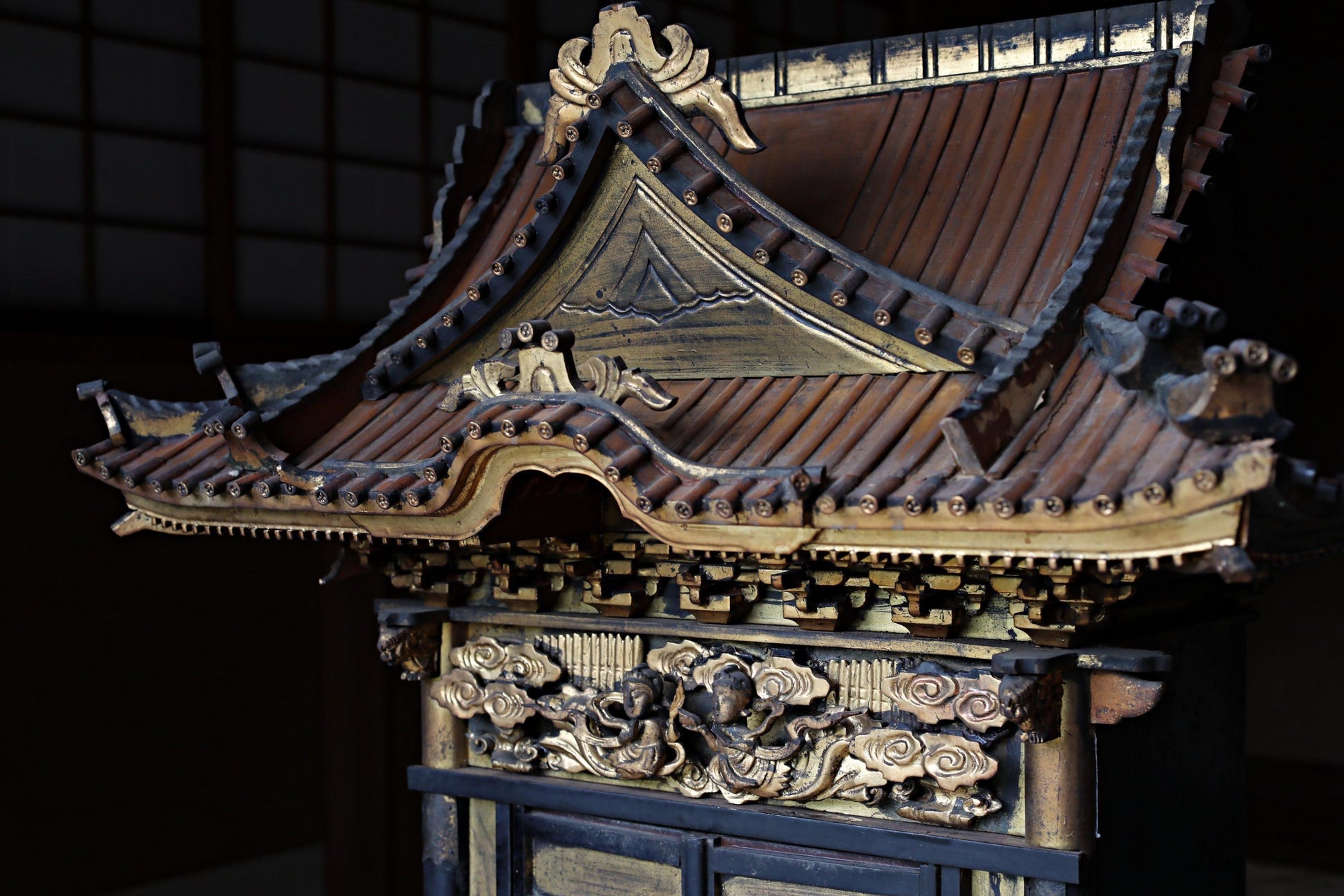 a traditional Japanese temple with intricate carvings and decorations, including a pointed roof and ornate details.