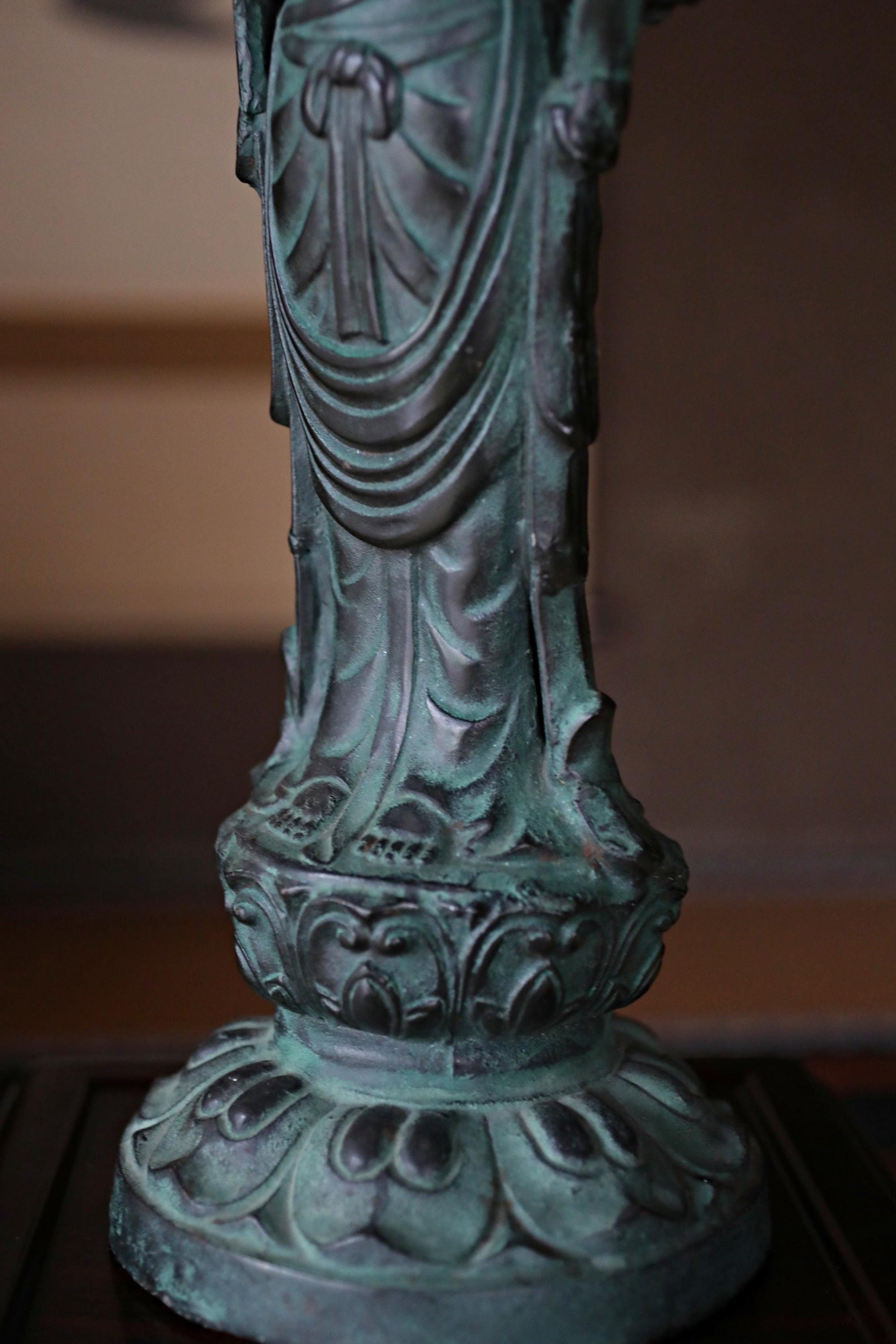 A close-up view of a decorative statue or sculpture, featuring intricate details and patterns.