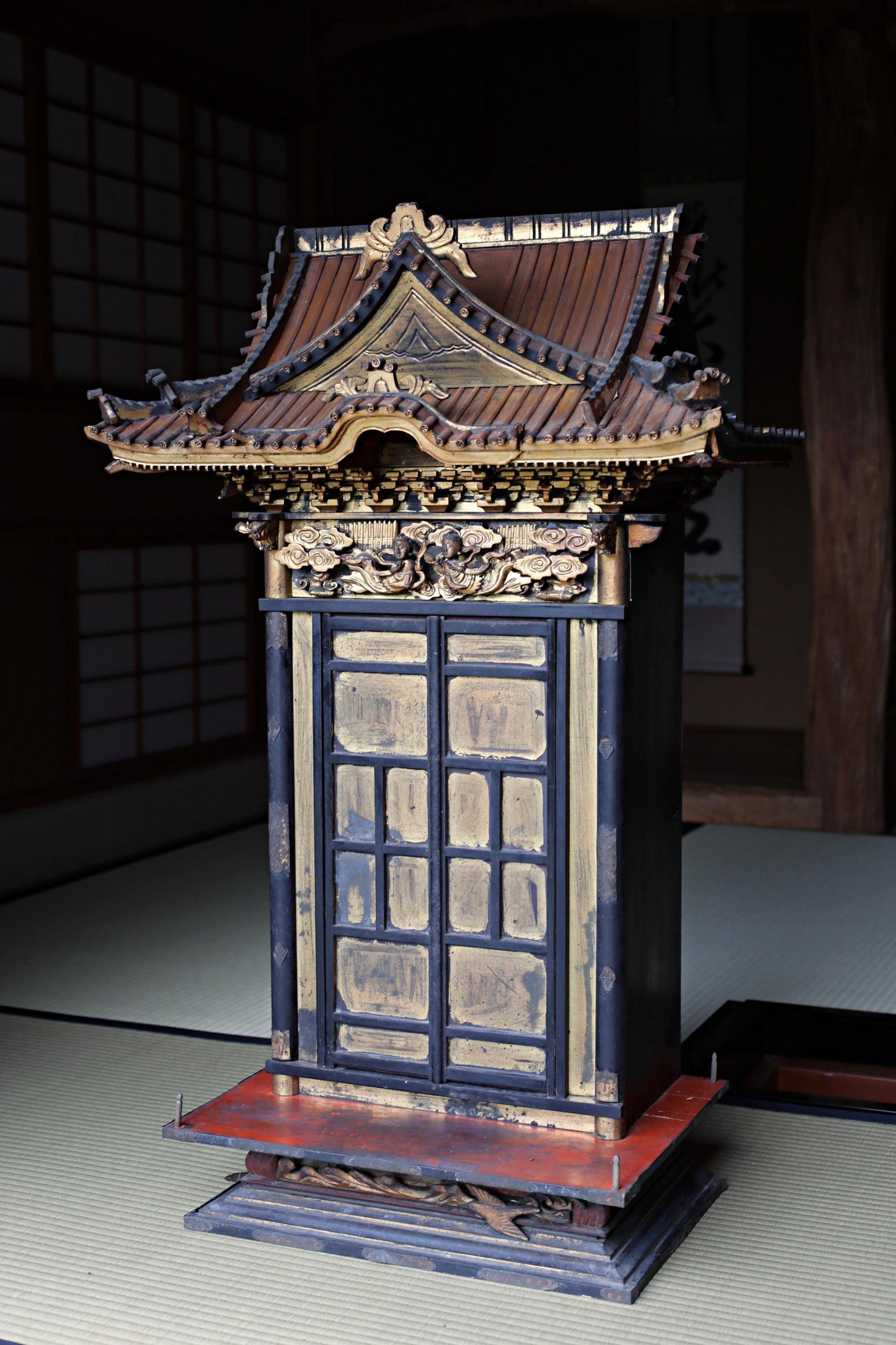 a traditional Japanese shrine with a wooden roof and intricate decorations.