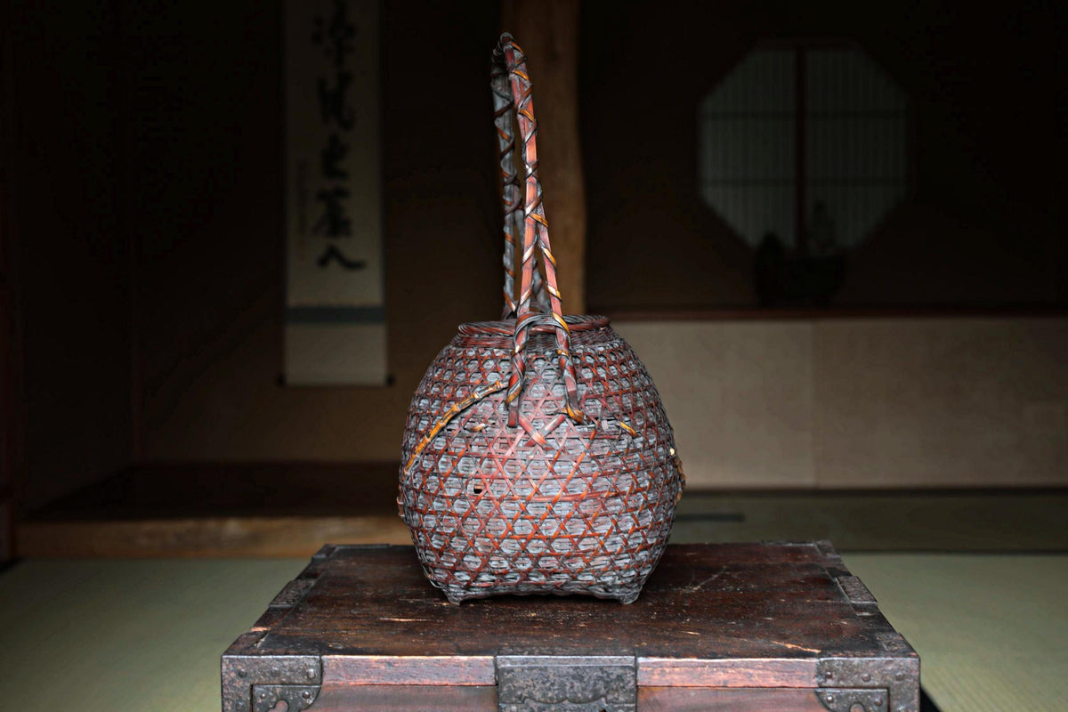 a traditional Japanese woven basket placed on a wooden box.
