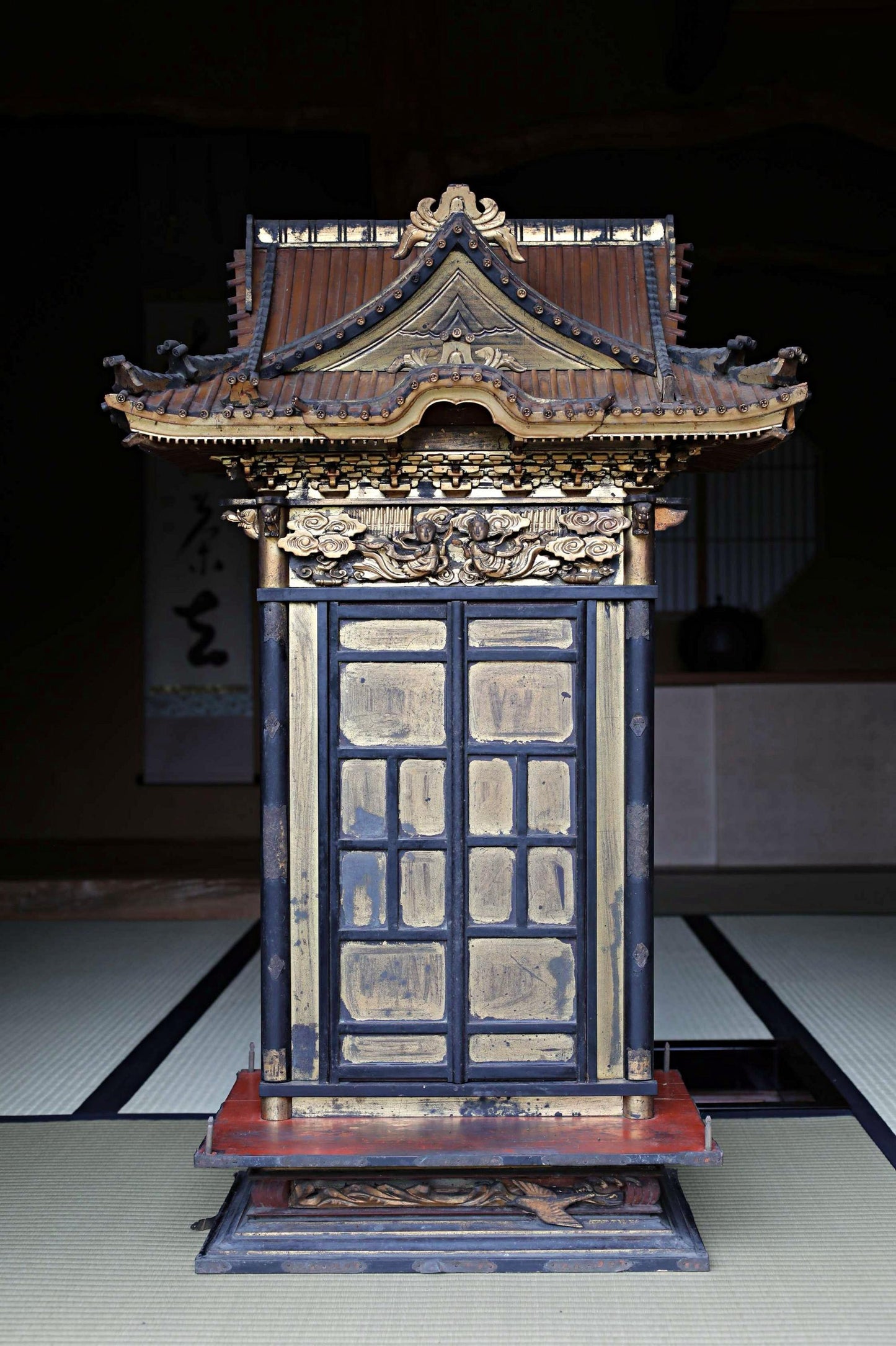 a traditional Japanese temple with a wooden roof and ornate decorations.