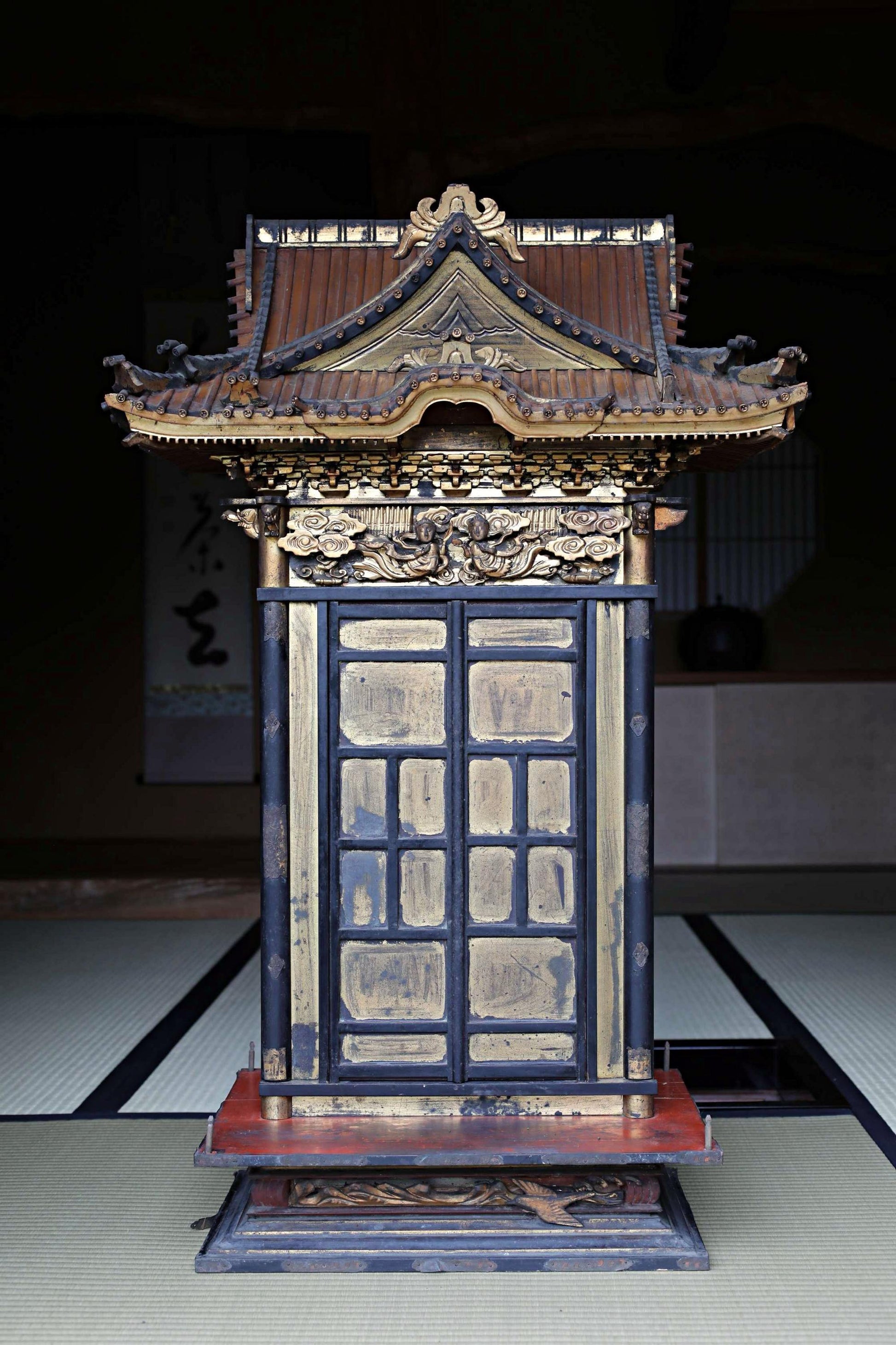 a traditional Japanese temple with a wooden roof and ornate decorations.