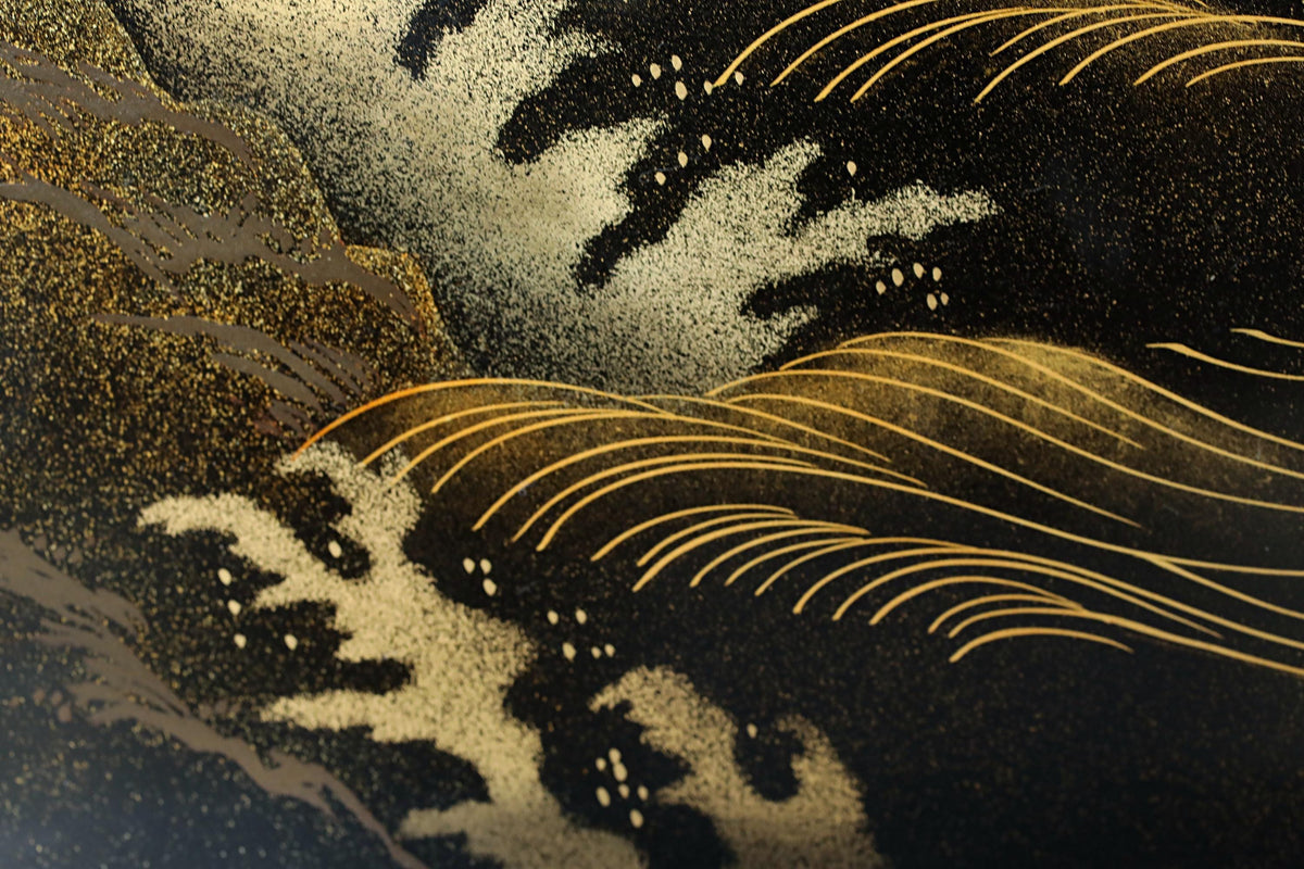 The image is a close-up of a black and gold pattern, featuring intricate lines and shapes that create a visually striking and artistic composition.