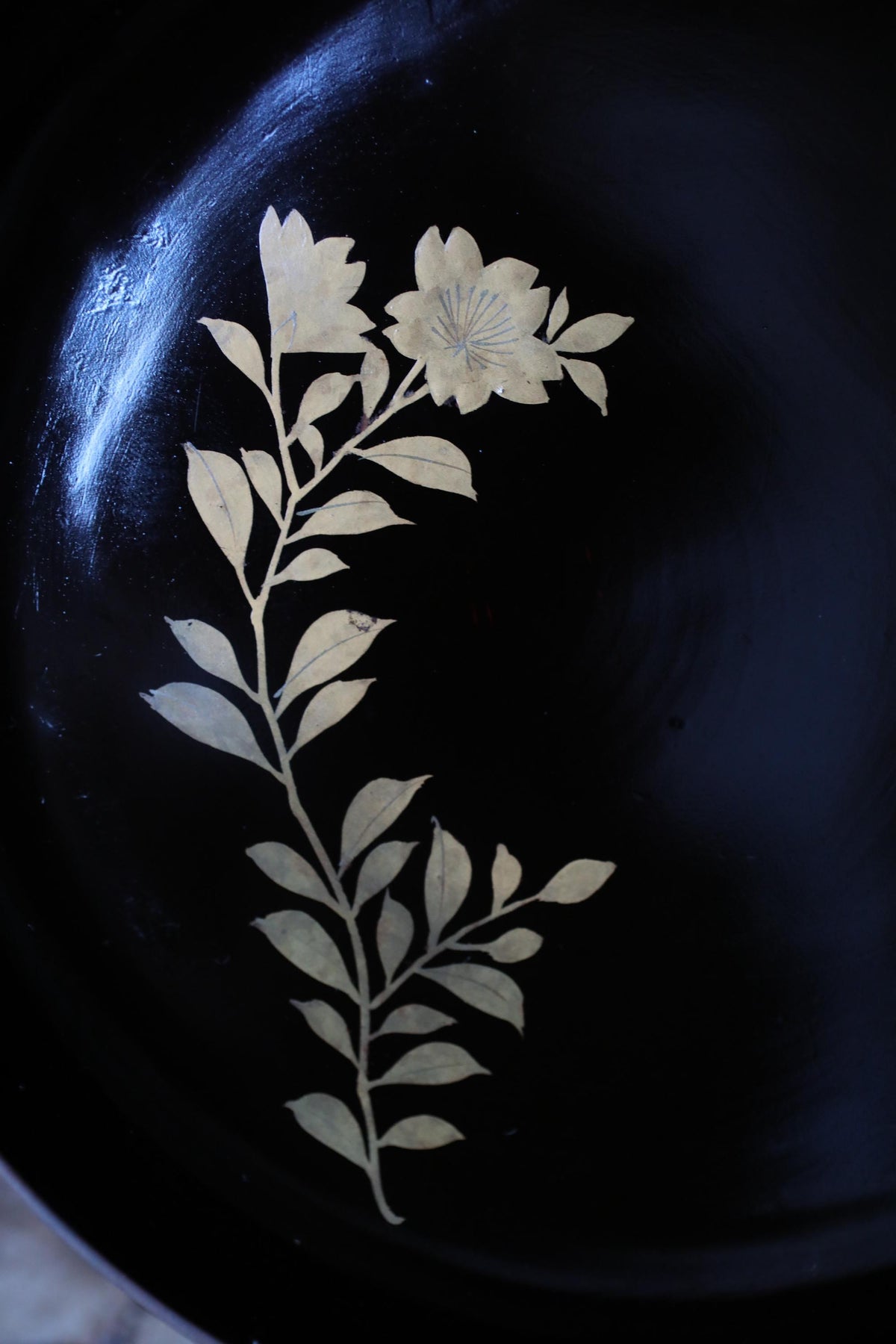 a close-up view of a black plate with a white floral design on it.