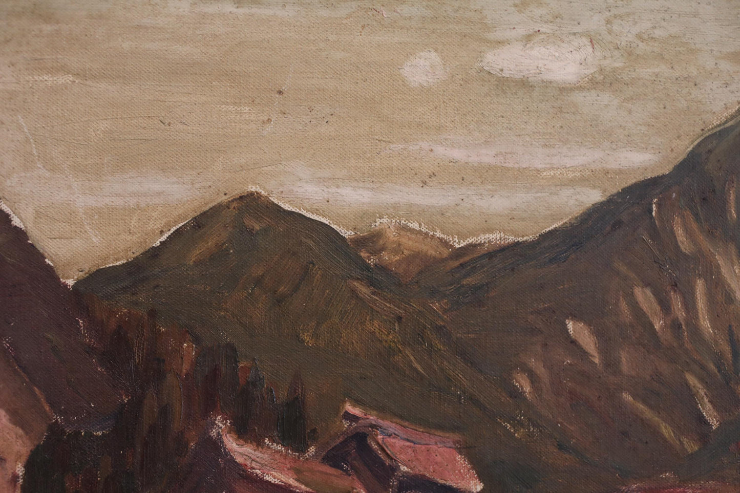 a mountainous landscape with a cloudy sky.