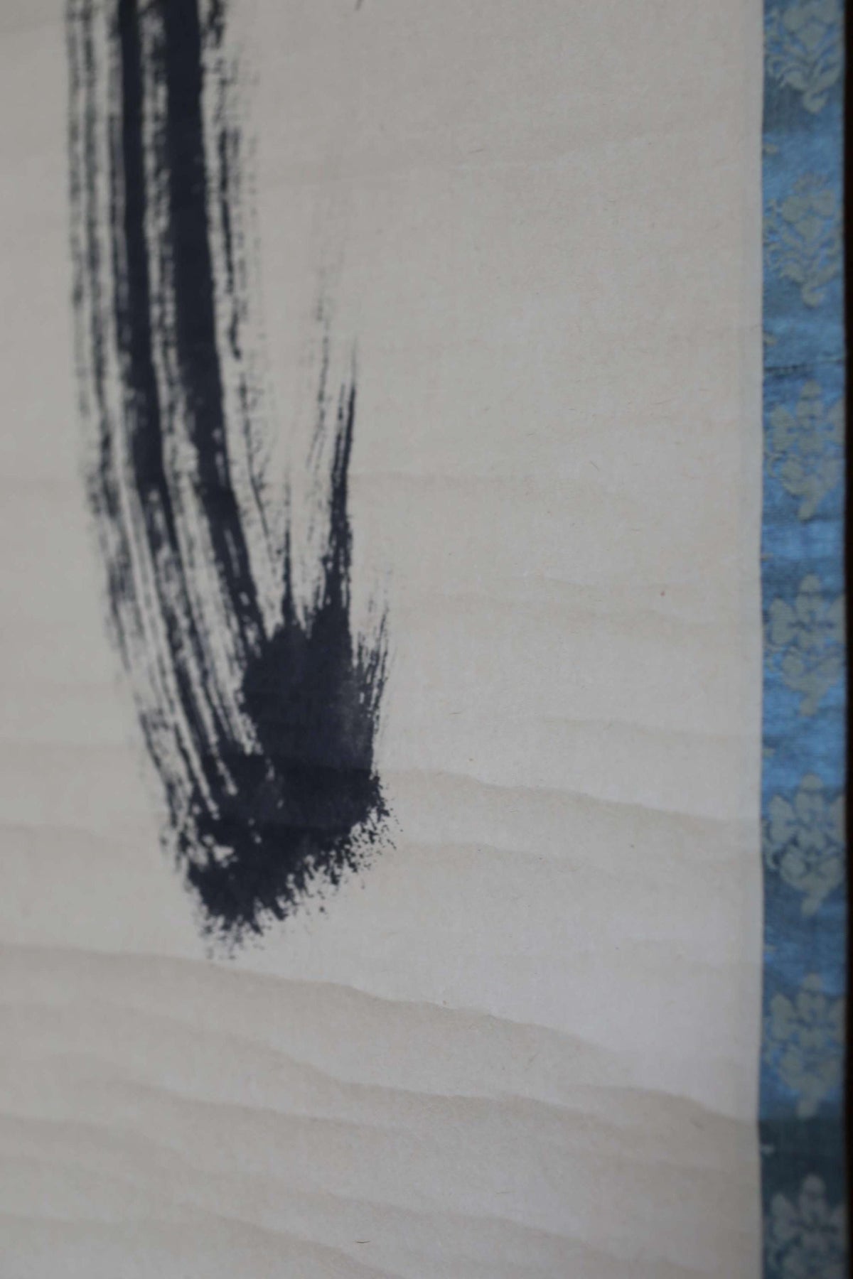 a close-up view of a black brush stroke on a white background.