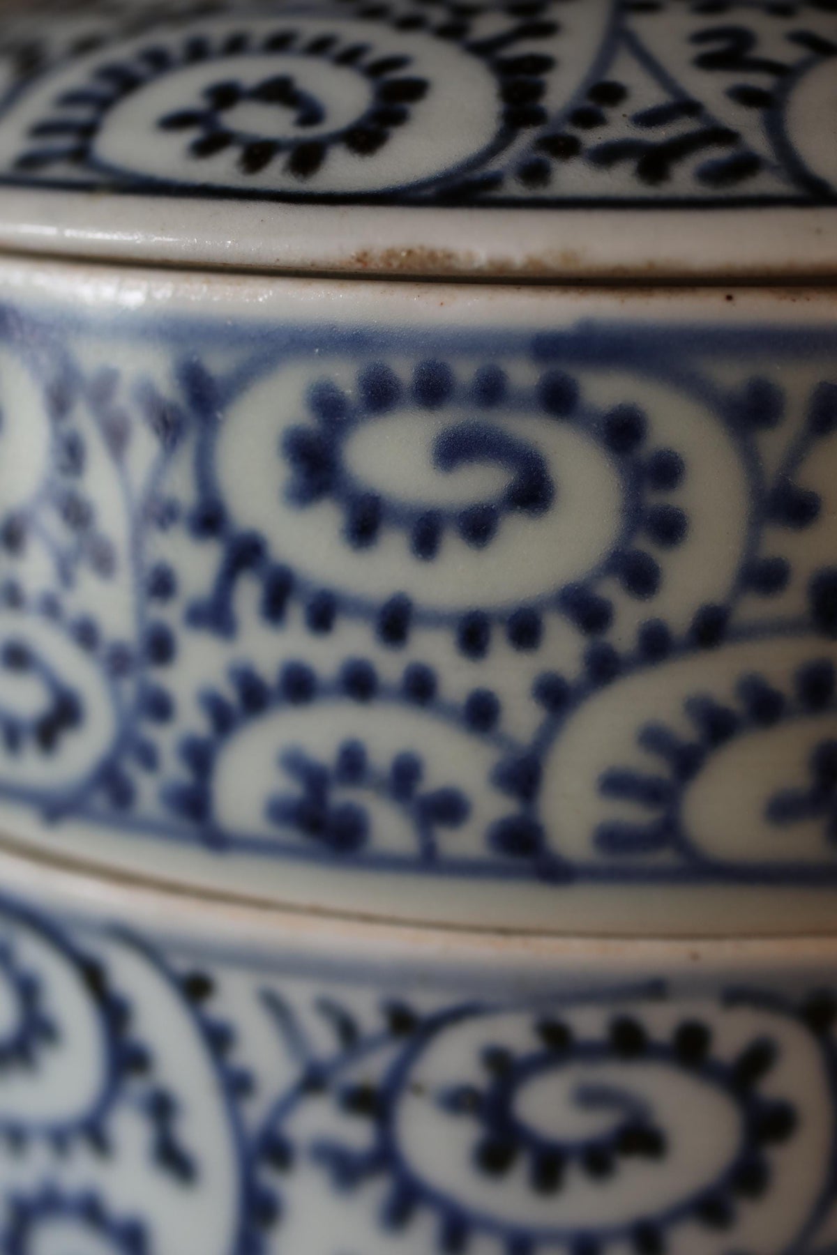 A close-up view of a decorative ceramic piece with a blue and white floral pattern.