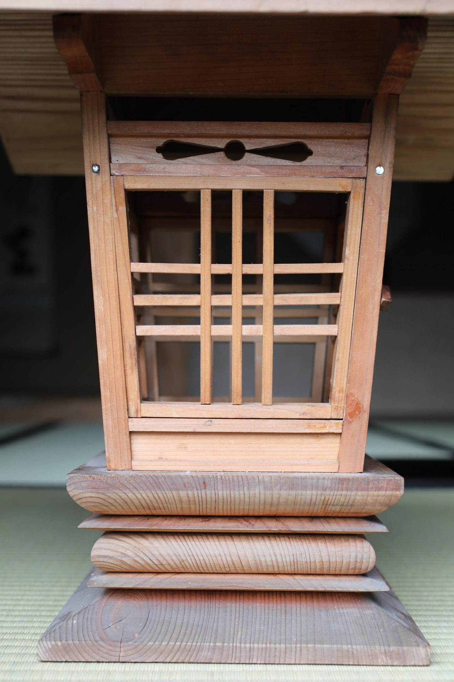 a wooden structure with a lattice-like design, possibly a piece of furniture or a decorative element.