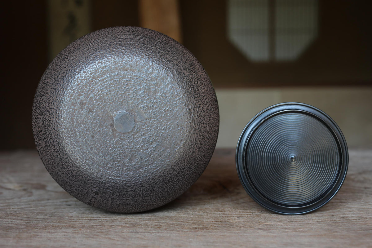 a close-up of two ceramic objects placed on a wooden surface.