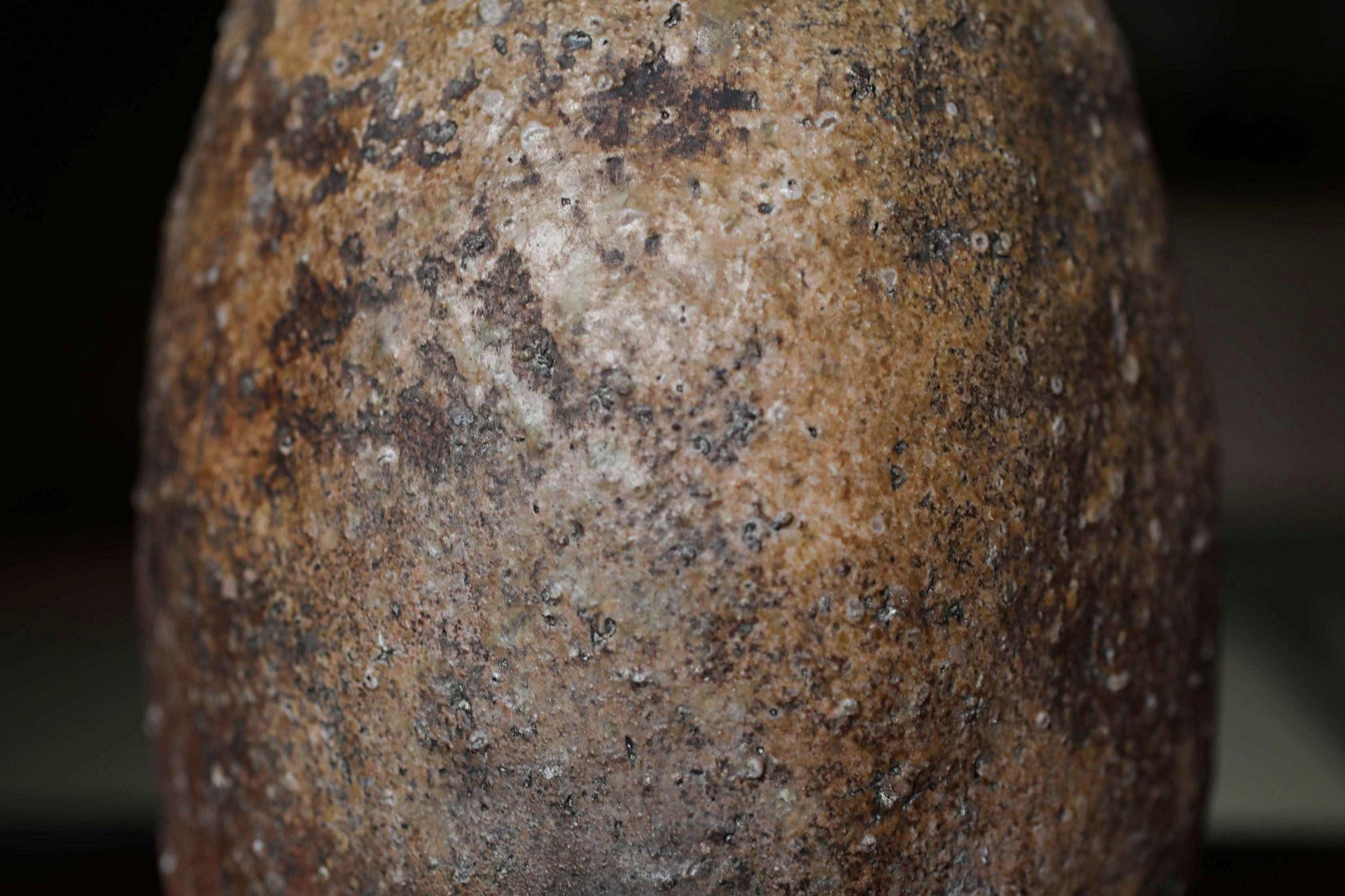 a close-up view of a weathered, rusted metal object with a textured, aged appearance.
