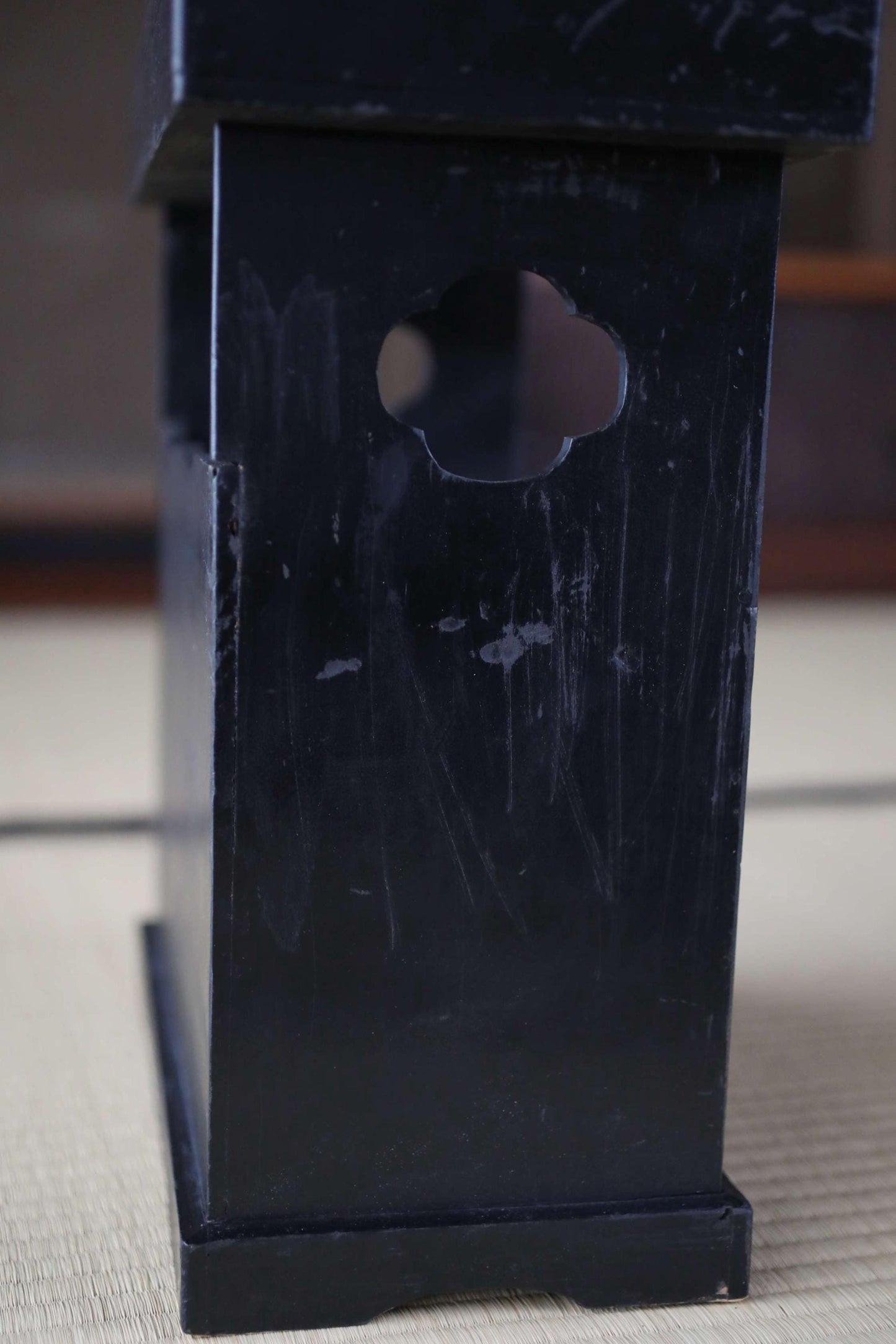 a black, rectangular object with a cutout in the center, sitting on a surface.