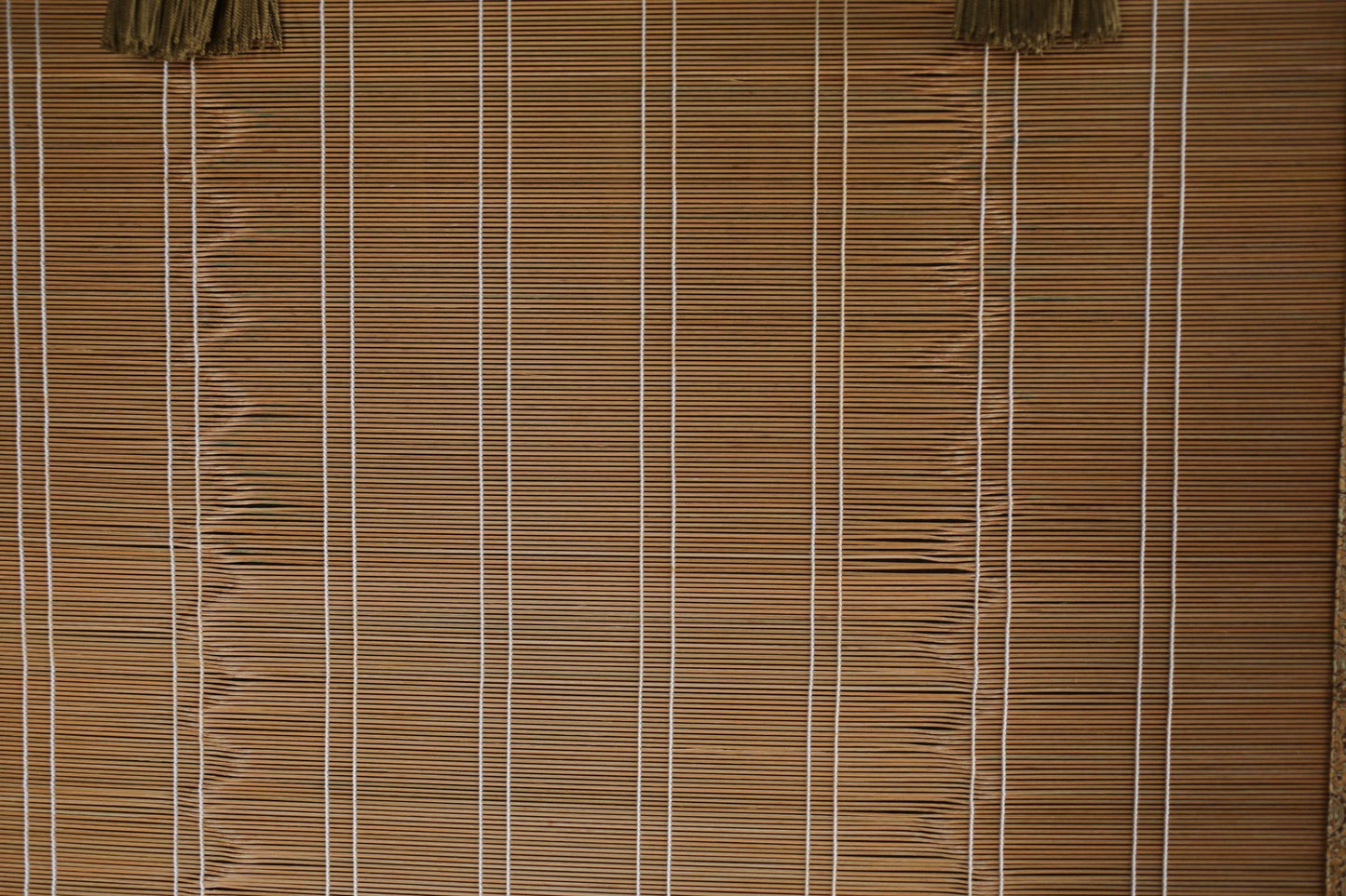 a close-up view of a bamboo blind with vertical slats, creating a textured and patterned appearance.