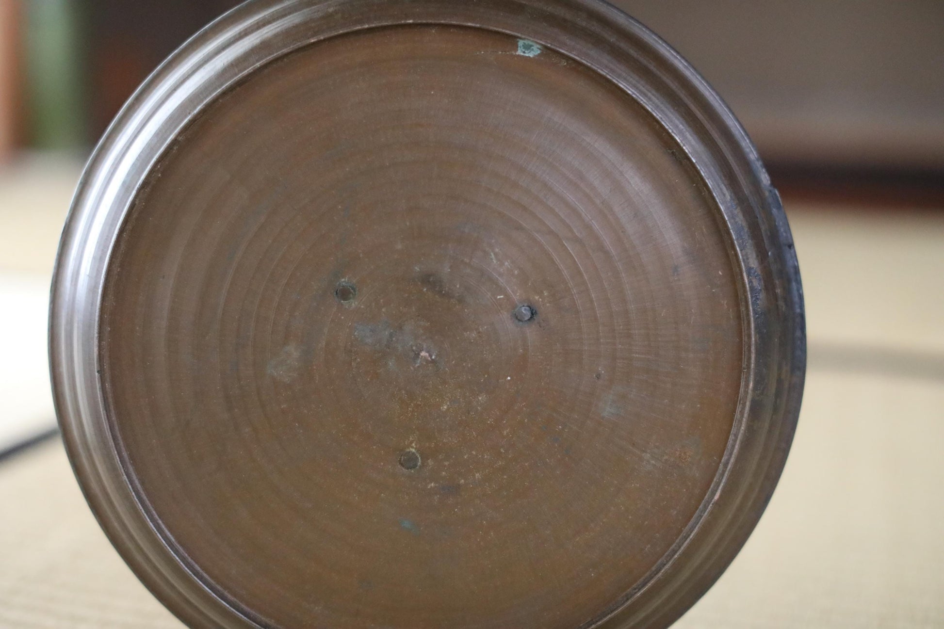 a close-up view of a circular, brown-colored object with a textured surface.