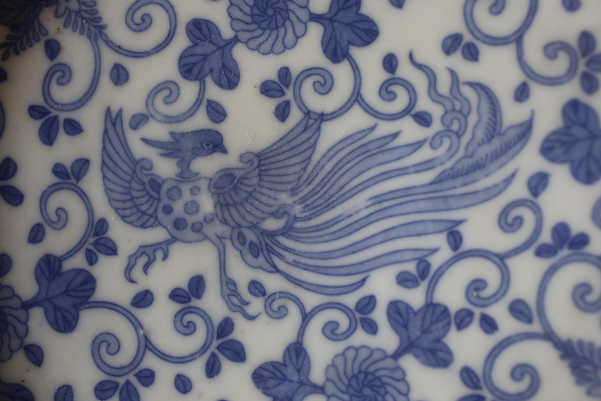 a close-up view of a decorative blue and white pattern with a stylized bird design.