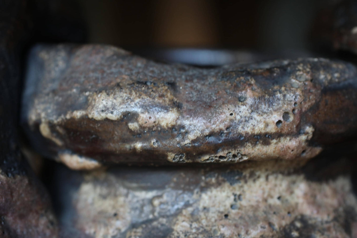 A close-up image of a weathered, rusty metal surface with a rough, textured appearance.