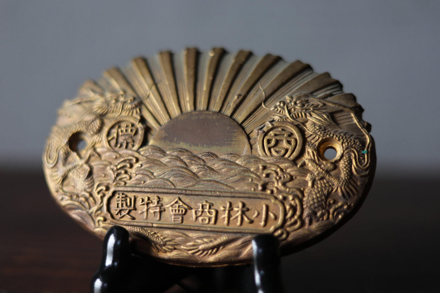 a close-up view of a decorative golden plaque or medallion with intricate designs and patterns.
