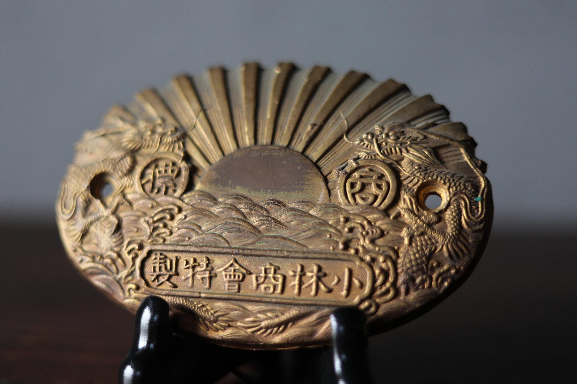a close-up view of a decorative golden plaque or medallion with intricate designs and patterns.