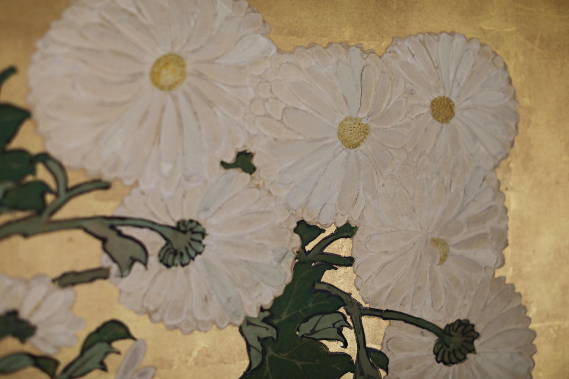 a close-up view of white flowers with green leaves, set against a golden background.