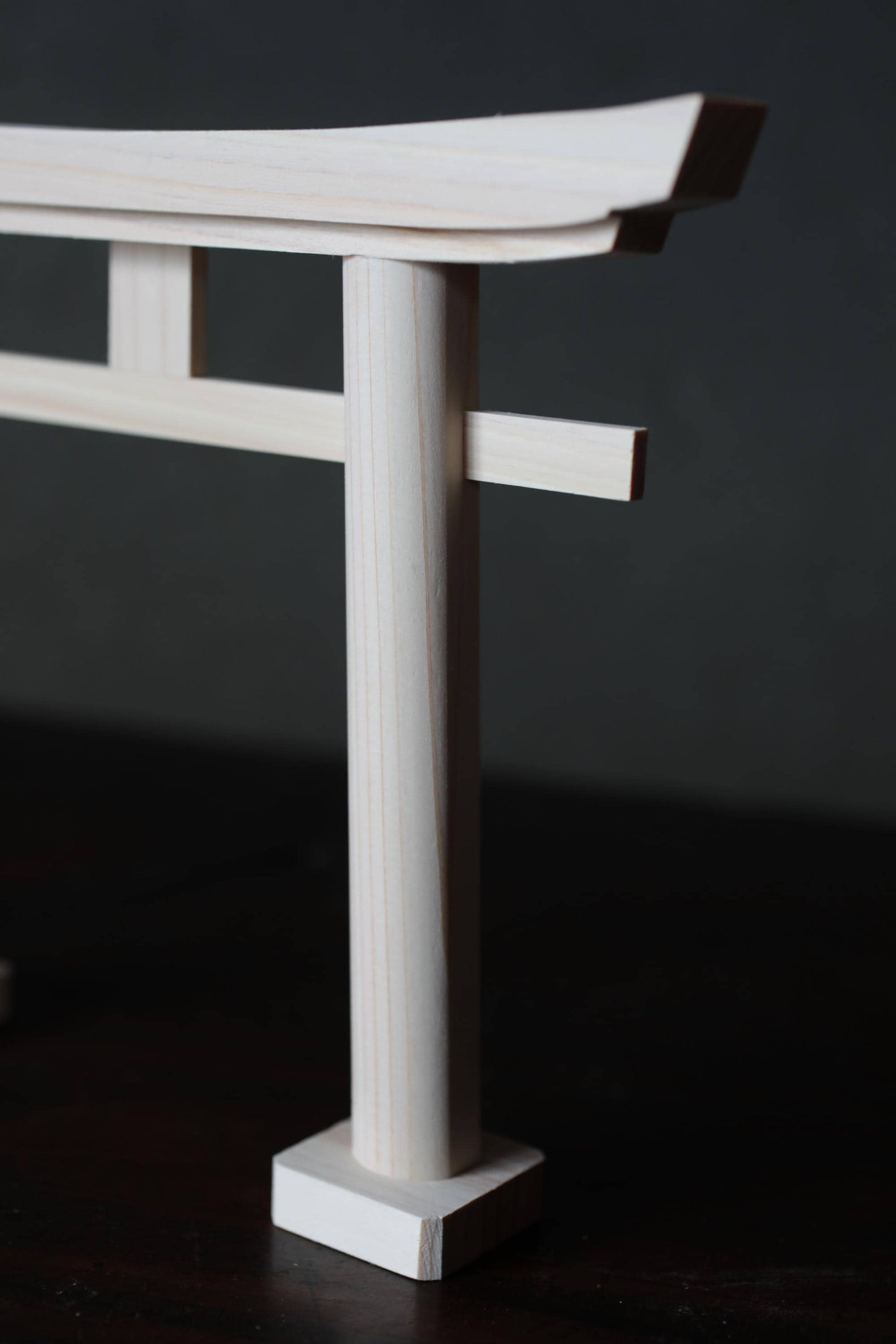 A close-up view of a wooden torii gate, a traditional Japanese gate used to mark the entrance to shrines.