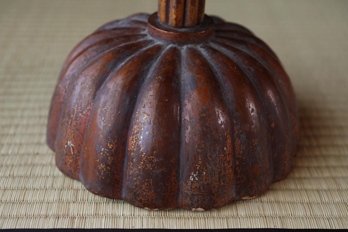 a close-up view of a rusted metal object, possibly a piece of furniture or a decorative item, with a textured surface.