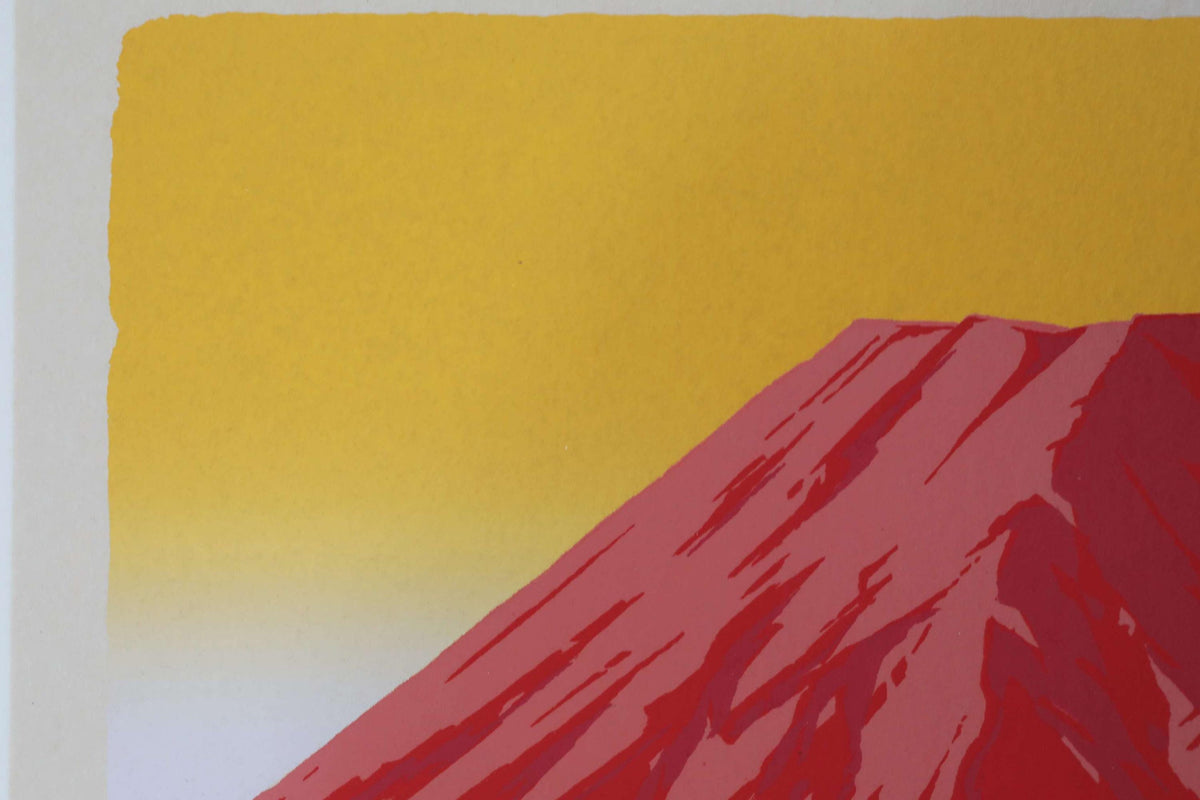a vibrant red mountain against a yellow sky.
