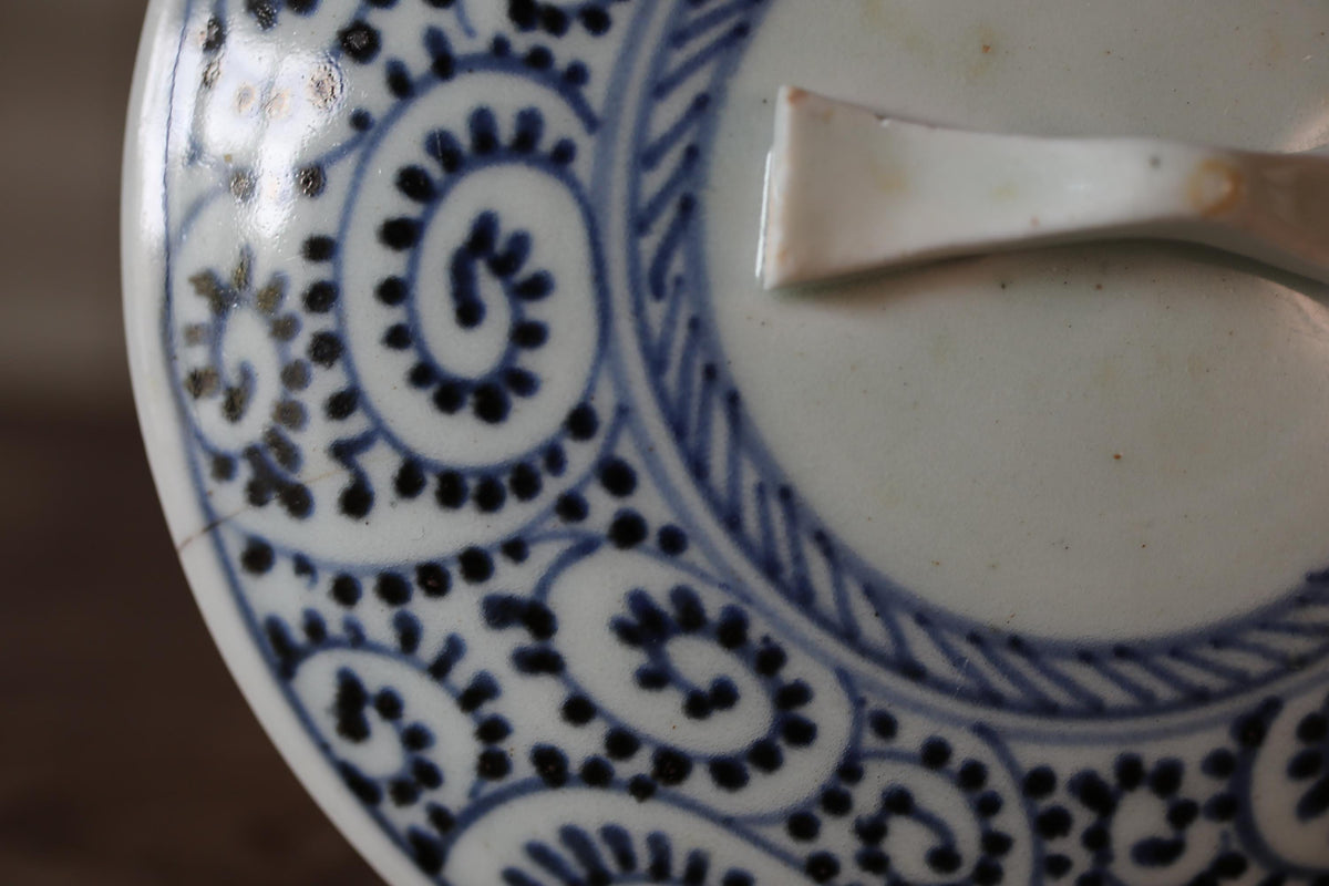 A close-up view of a decorative blue and white plate with intricate patterns and designs.