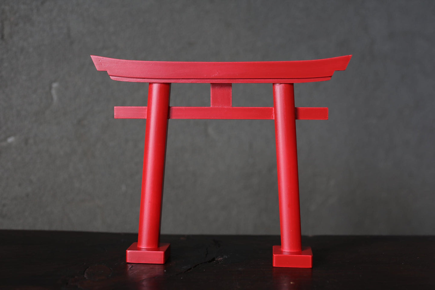 A red torii gate, a traditional Japanese Buddhist gate, is prominently featured in the image.