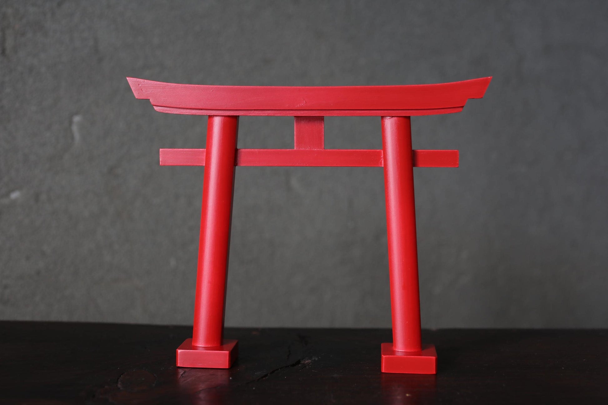 A red torii gate, a traditional Japanese Buddhist gate, is prominently featured in the image.
