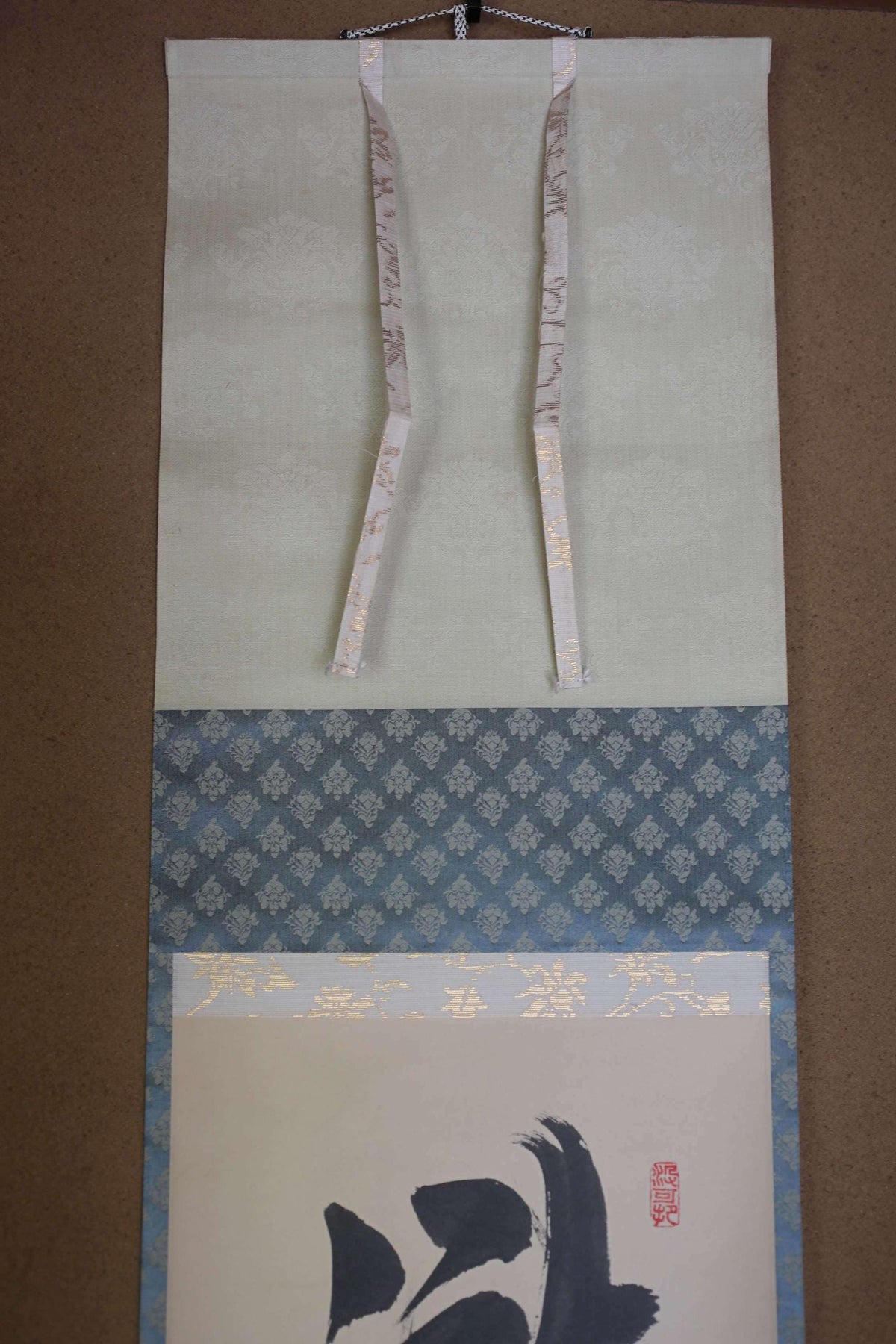 a decorative scroll with a floral pattern and a calligraphy design on it.