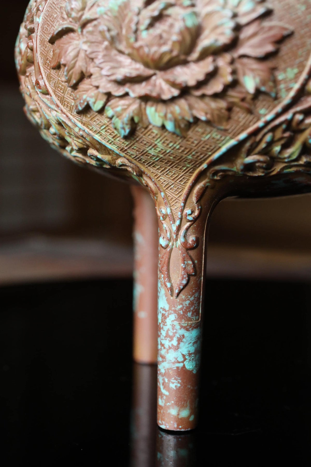 a close-up view of a decorative vase with intricate floral designs on its surface.