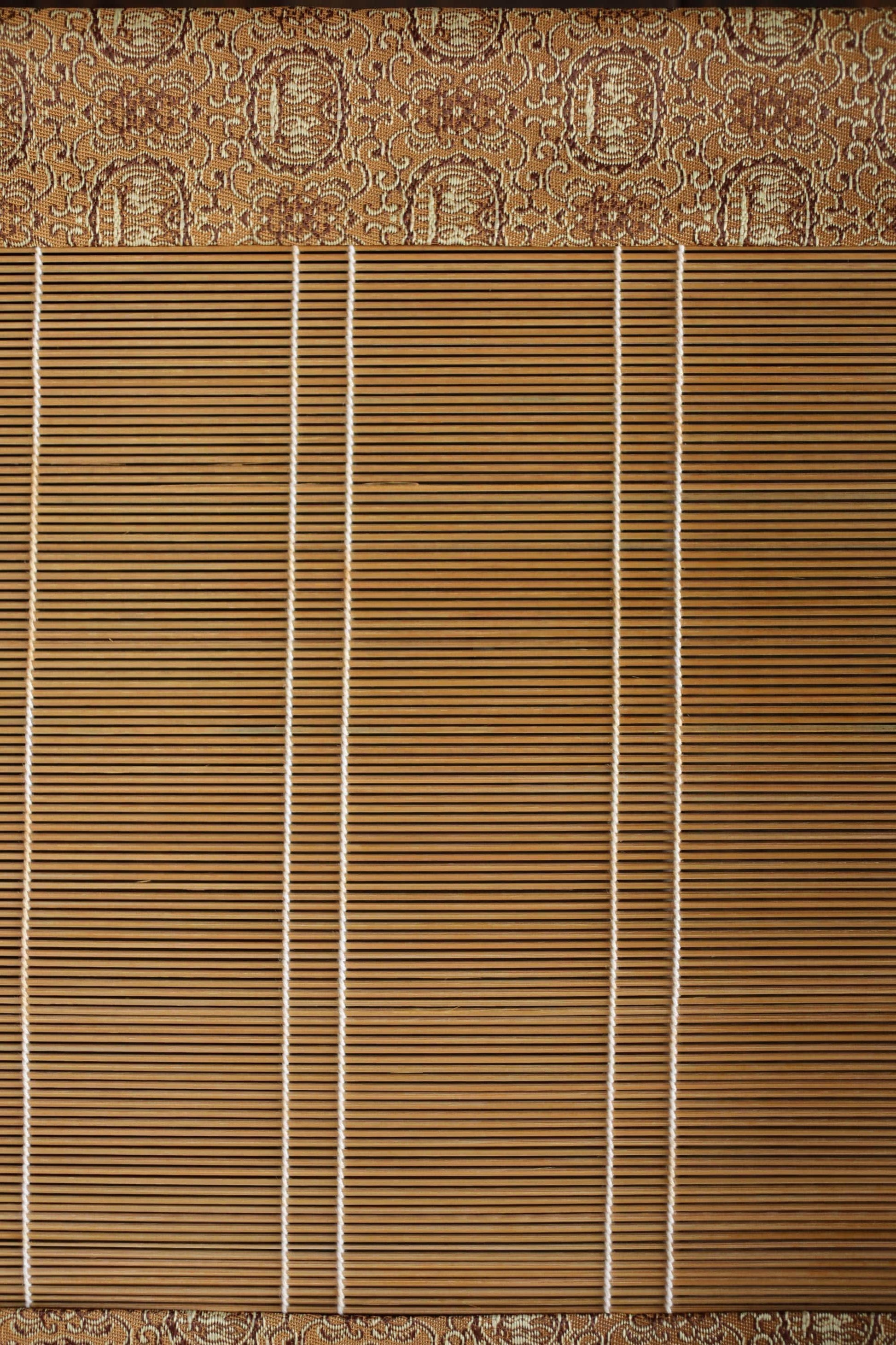 a close-up view of a wooden blind with vertical slats, creating a textured and patterned appearance.