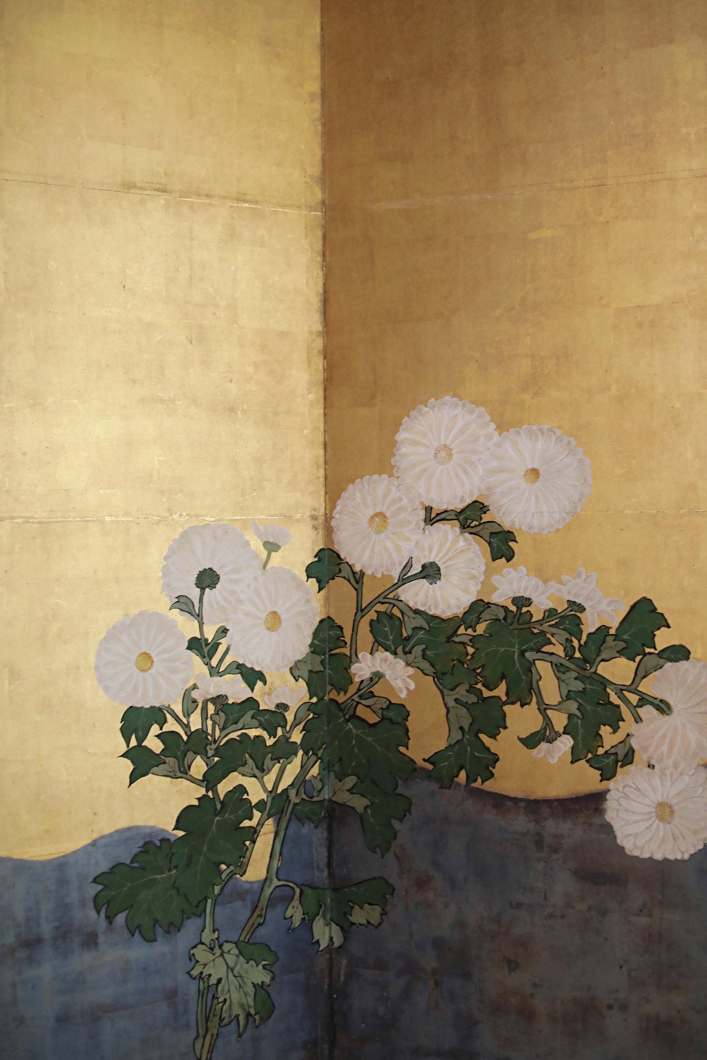 a vibrant floral arrangement with white chrysanthemum flowers against a warm yellow background.