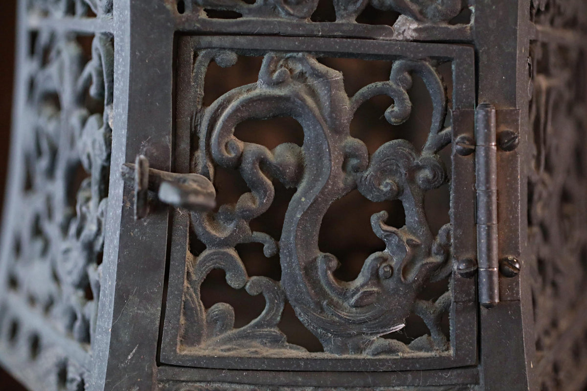 an ornate metal door with intricate designs and patterns, including a dragon or phoenix motif.