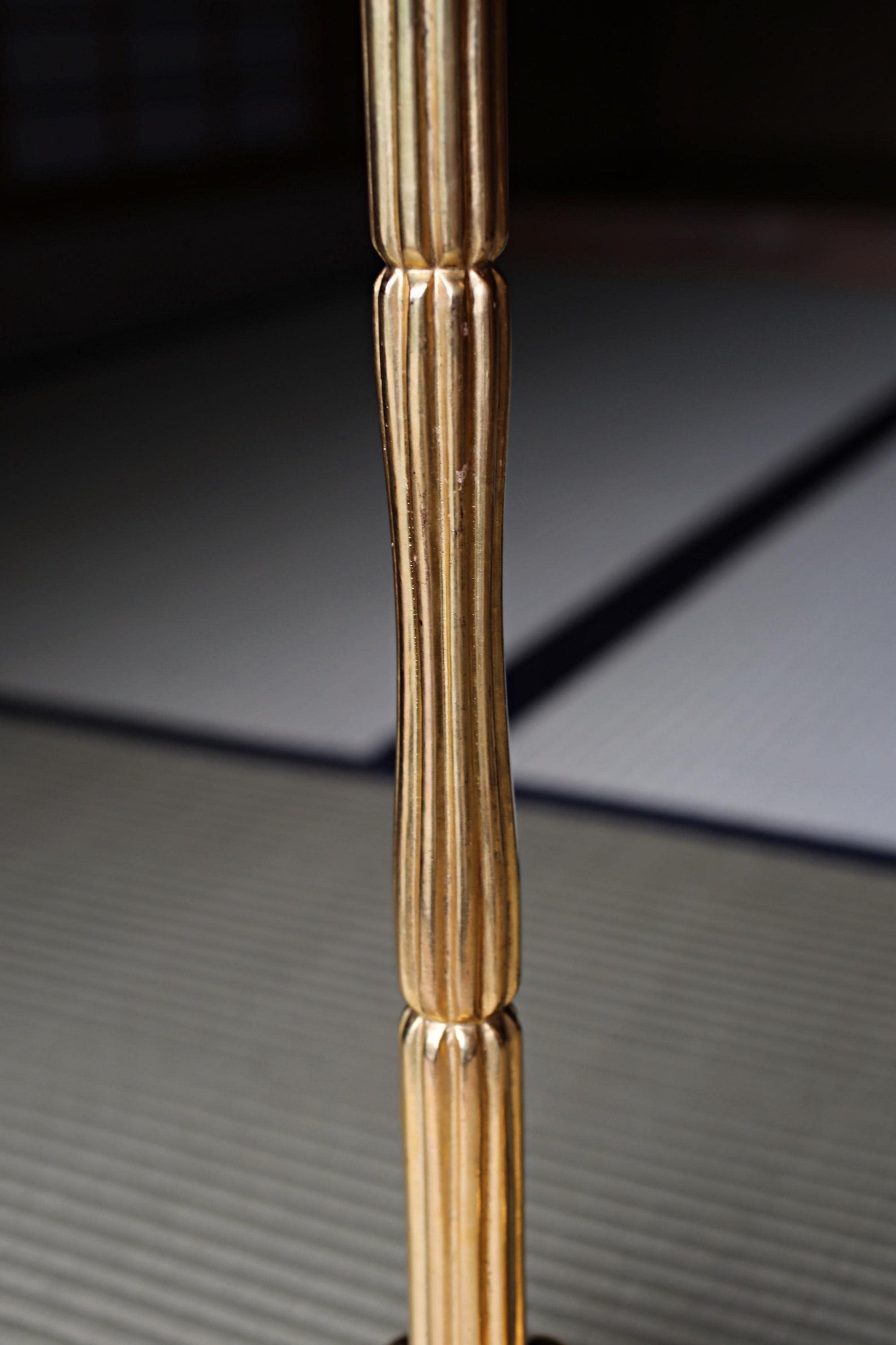 a close-up view of a golden, ornate pole or column with a textured surface.