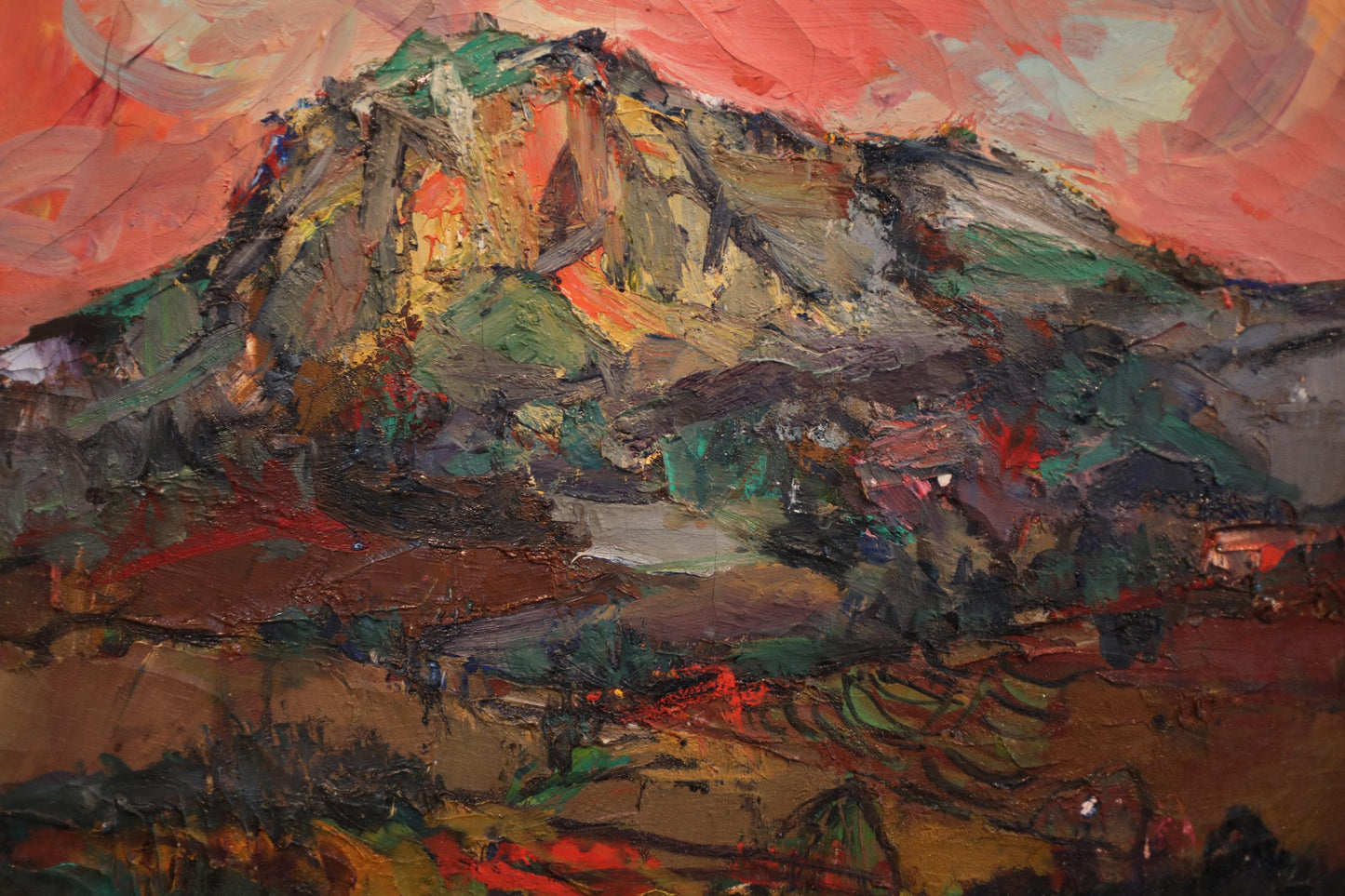 The image is an oil painting depicting a mountainous landscape with a vibrant, colorful palette of red, orange, green, and blue.