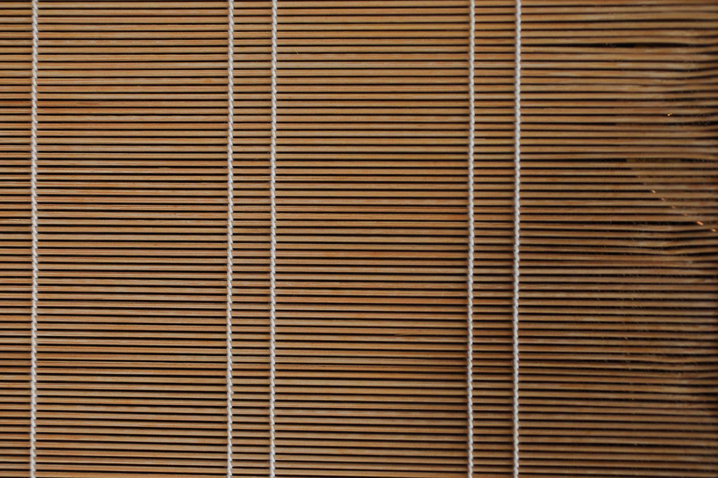 a close-up view of a wooden blind with vertical slats, creating a textured and patterned appearance.