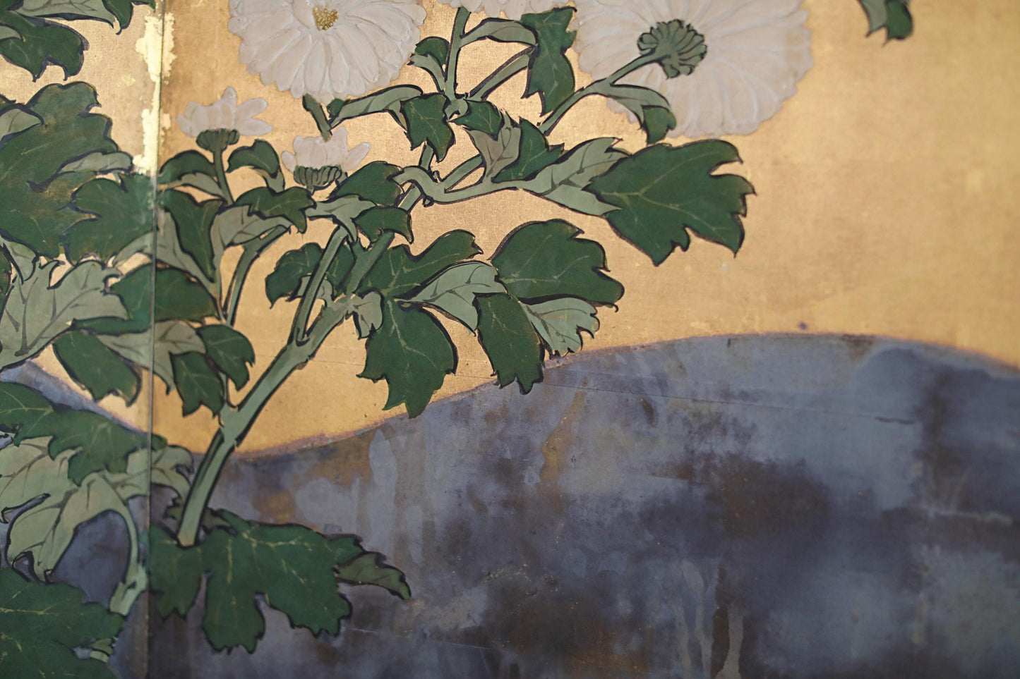 The image is a close-up of a painting featuring a branch with green leaves and white flowers against a blue background.